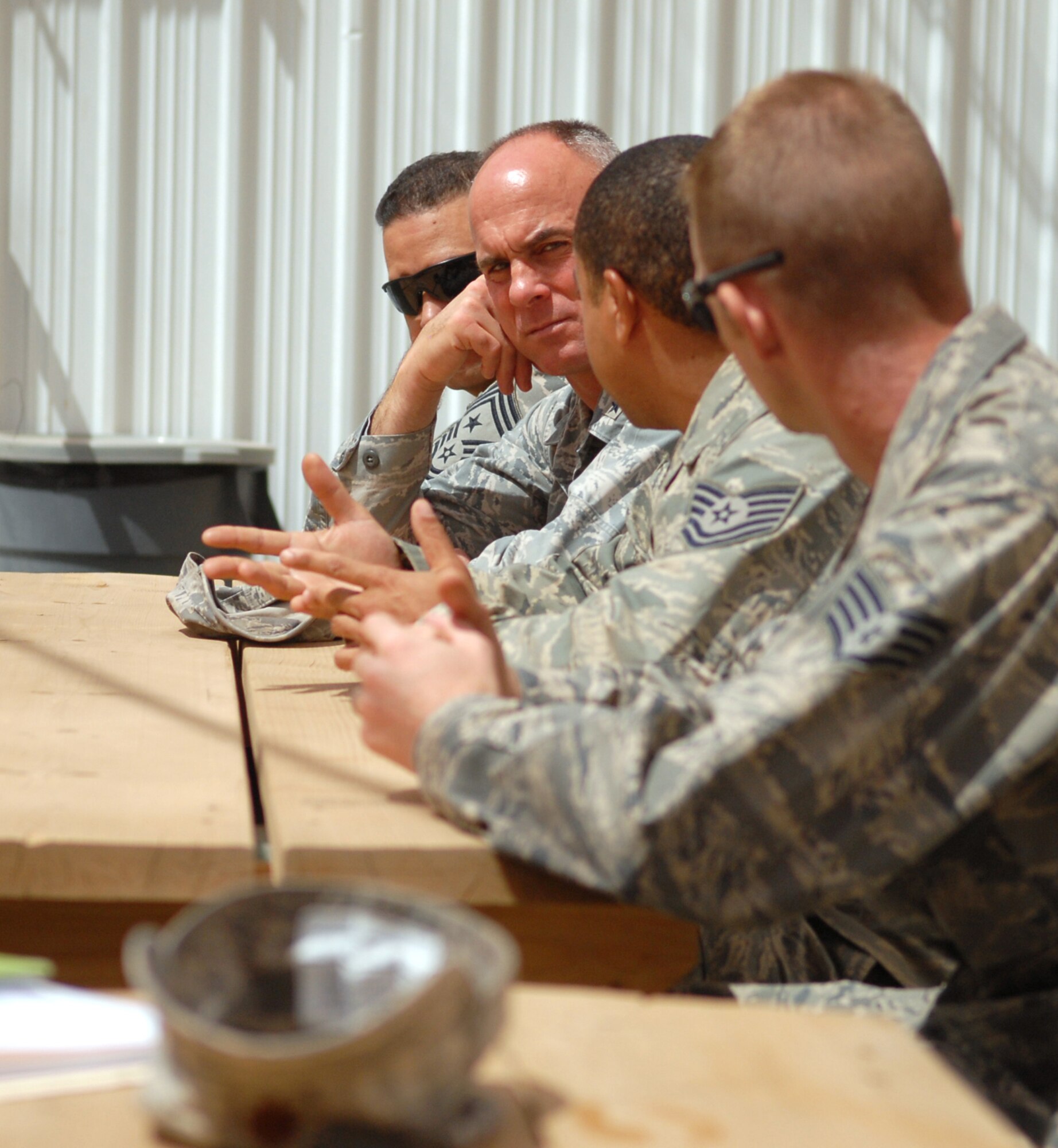 Brig. Gen. Craig Franklin, the 332nd Air Expeditionary Wing commander, speaks with members of the 732nd Expeditionary Logistics Readiness Squadron redistribution property assistance team at forward-operating-base Kalsu, Iraq. The Airmen at the RPAT yard relieve demobilizing units in the local area of excess theater-provided equipment. In doing so, the RPAT reestablishes accountability, enables asset visibility of the received equipment and allocates transportation methods for the flagged provisions.