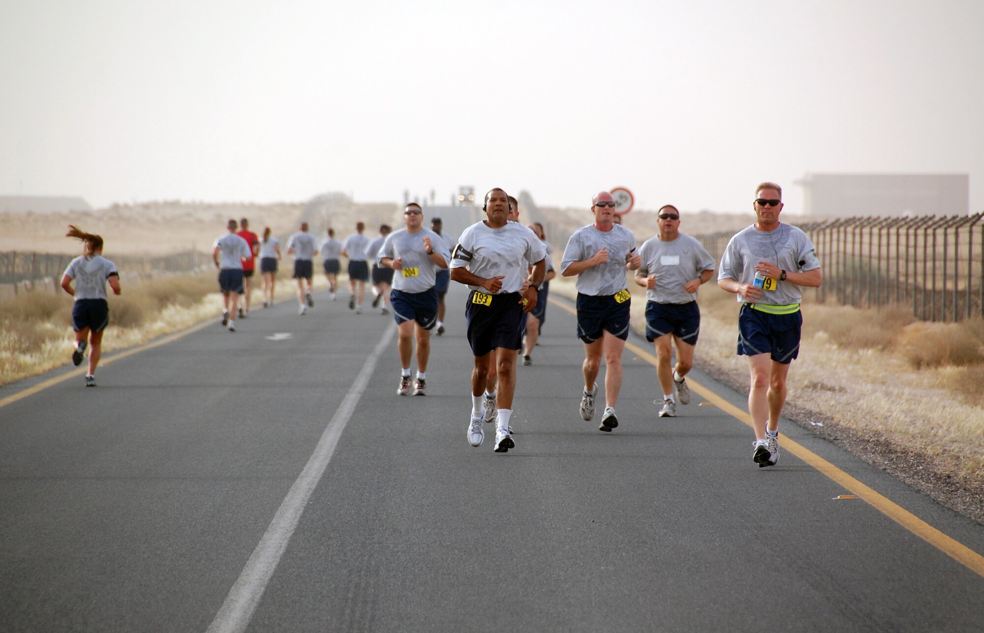 U.S. Air Force Airmen and civilians compete in a Memorial Day 10K fun run May 31, 2010 at an air base in Southwest Asia. The 386th Expeditionary Force Support Squadron fitness center staff hosted the early morning run with the help of base volunteers. (U.S. Air Force photo by Tech. Sgt. Lindsey Maurice/Released)