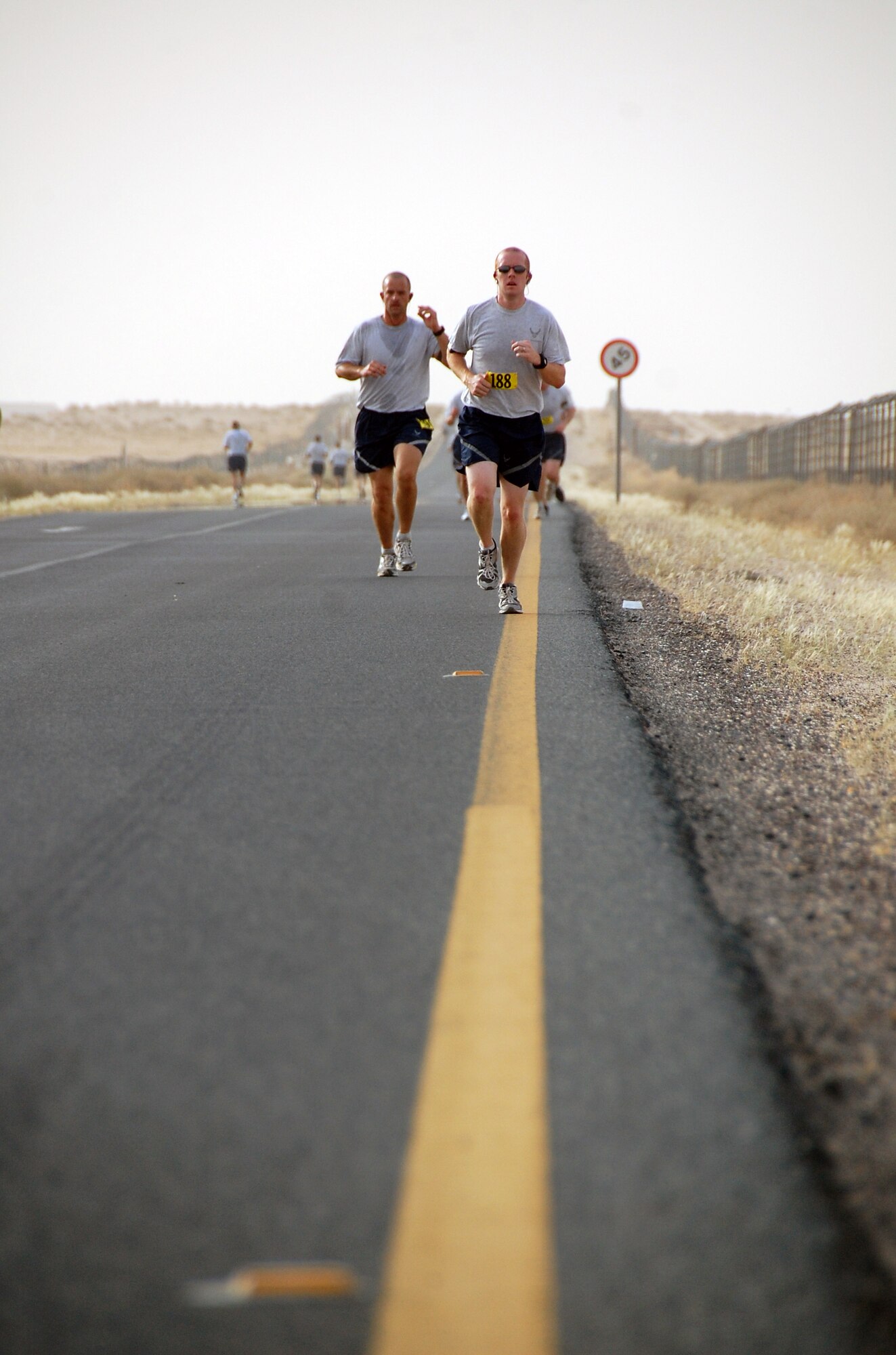 Front, U.S. Air Force Capt. James Willliams of the 737th Expeditionary Airlift Squadron approaches the turnaround point of a Memorial Day 10K fun run May 31, 2010 at an air base in Southwest Asia. The 386th Force Support Squadron fitness center staff hosted the early morning run with the help of base volunteers. (U.S. Air Force photo by Tech. Sgt. Lindsey Maurice/Released)