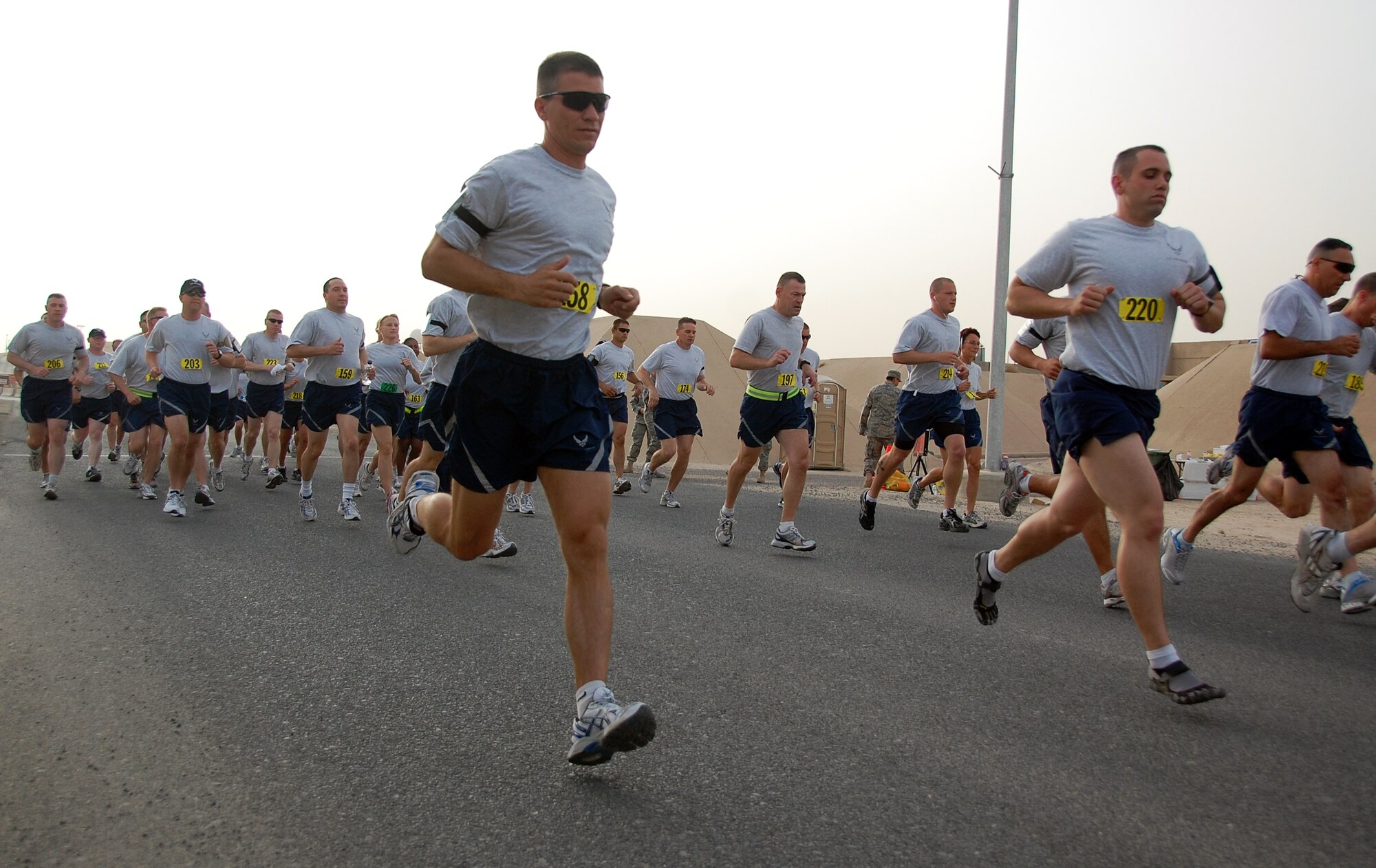 U.S. Air Force Capt. Gregory Cameron, foreground, and other Airmen set out on a Memorial Day 10K fun run May 31, 2010 at an air base in Southwest Asia. Captain Cameron, who is deployed with the 386th Expeditionary Maintenance Group, took first place in the run at 42:22. (U.S. Air Force photo by Tech. Sgt. Lindsey Maurice/Released)