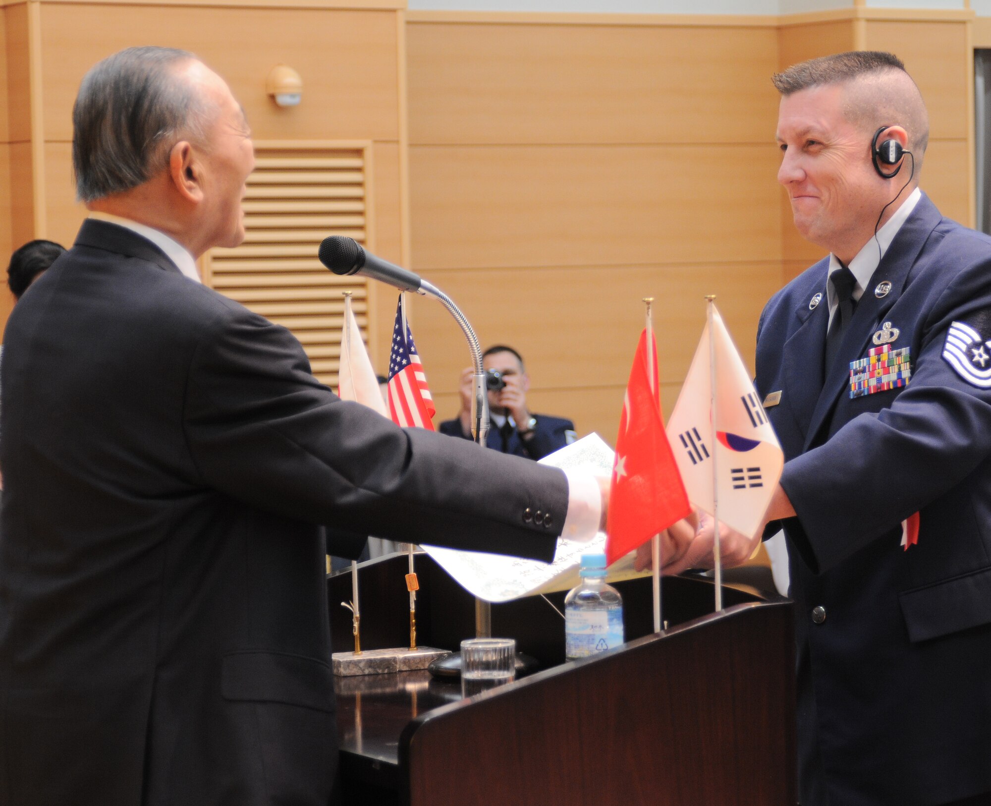 YOKOTA AIR BASE, Japan -- Master Sgt. Erik Waugaman, 374th Operations Support Squadron station chief, accepts the Good Conduct Association of Japan award, or Nippon Zenkokai, from Mr. Kosho Kawamura, President Japan Good Deed Association, May 22 during a ceremony at Meiji Shrine in Tokyo. (U.S. Air Force photo/Katrina R. Menchaca)