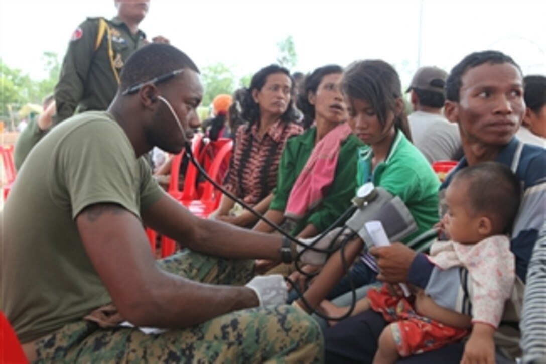 U.S. Navy Petty Officer 3rd Class Clyde M. Fisher, a hospital corpsman with 3rd Medical Battalion, Combat Logistics Regiment 35, takes a patient's blood pressure in the triage area of the Kampong Chhnang Friendship Clinic during the Cambodia Interoperability Program in Kampong Chhnang province, Cambodia, on May 13, 2010.  The Cambodia Interoperability Program is a collaboration of the Royal Cambodian Armed Forces and U.S. military to promote international cooperation and community relations through humanitarian missions.  