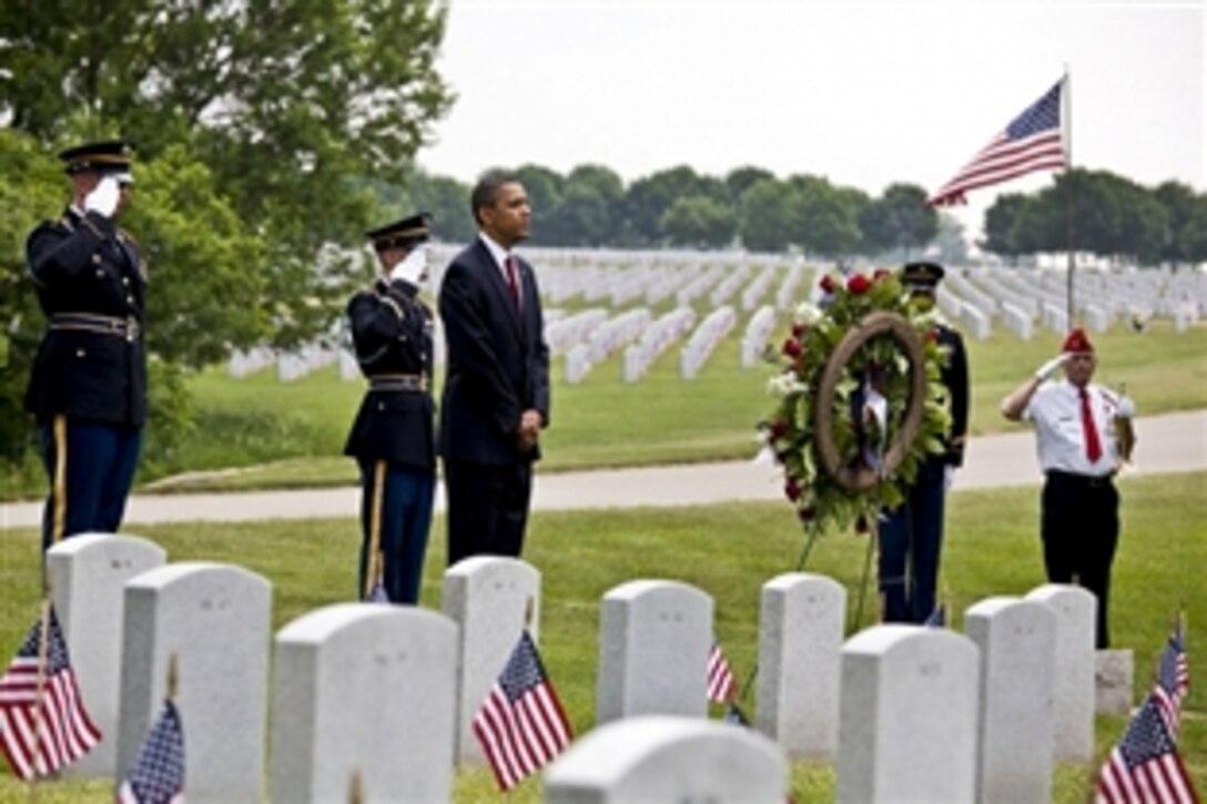 President Barack Obama stands after laying a wreath in Abraham Lincoln National Cemetery in Elwood, Ill., on Memorial Day, May 31, 2010.