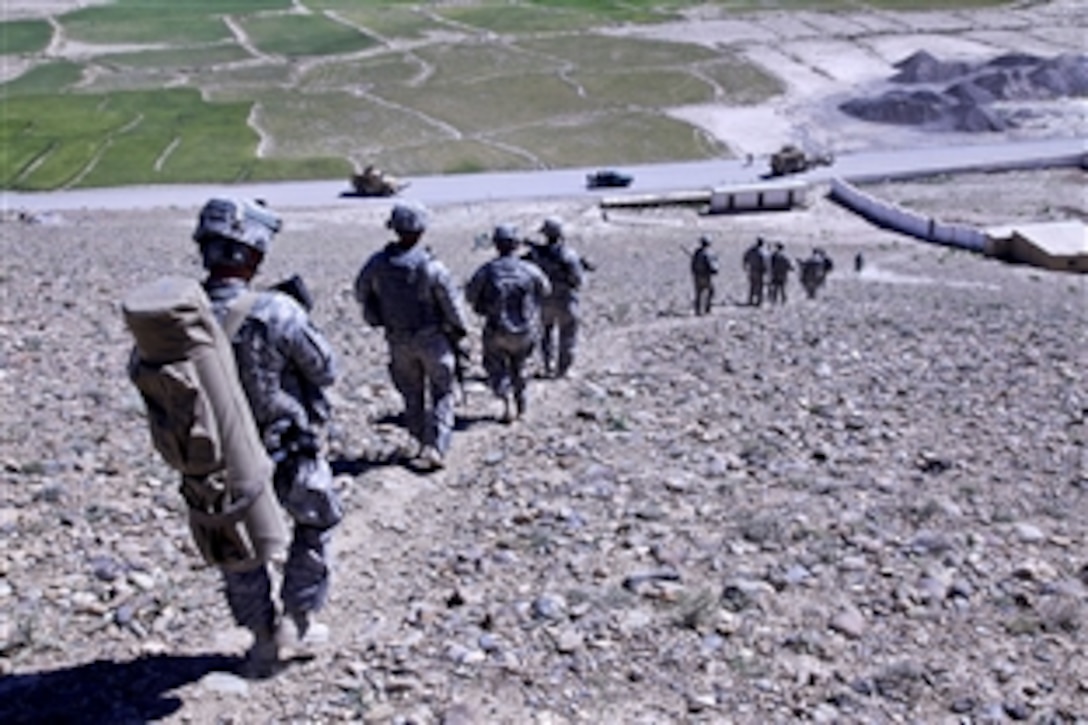 Members of the 401st Military Police travel through the village of Hesarak in Logar province, Afghanistan, May 30, 2010  