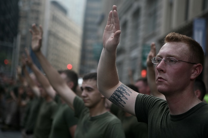 NEW YORK - Marines with Special Purpose Marine Air Ground Task Force New York raise their hands at the World Trade Center site after their commanding officer asked who among them enlisted after the Sept. 11 terrorist attacks. The Marines joined Sailors, Coast Guardsmen, New York police and firefighters in a memorial run to Ground Zero as part of Fleet Week New York 2010. (Official Marine Corps photo by Lance Cpl. Jad Sleiman)