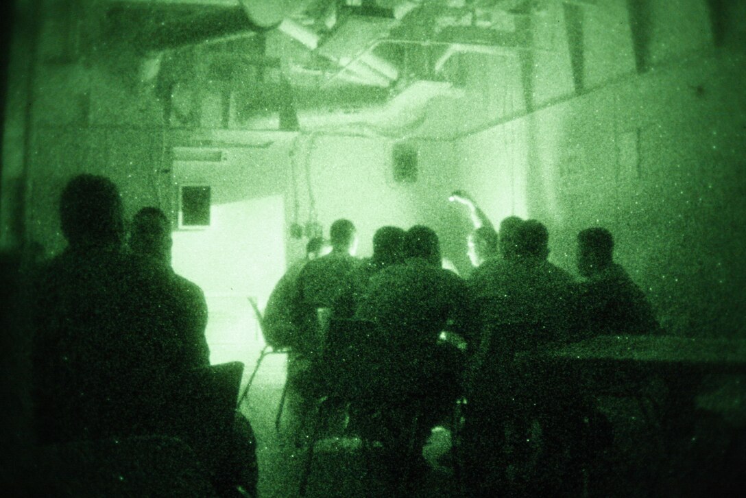 Marines with 1st Battalion, 7th Marine Regiment, continue playing card games during a power outage aboard the USS Bonhomme Richard June 2. The Marines got a taste of ship life for the first time when they participated in exercise Dawn Blitz May 31 to June 4.