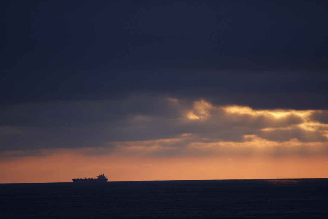 A Naval vessel floats along the horizon far away from the USS Bonhomme Richard June 3. Marines from 1st Battalion, 7th Marine Regiment, aboard the ship participated in an exercise known as Dawn Blitz, a ship-to-sea-to-land exercise.