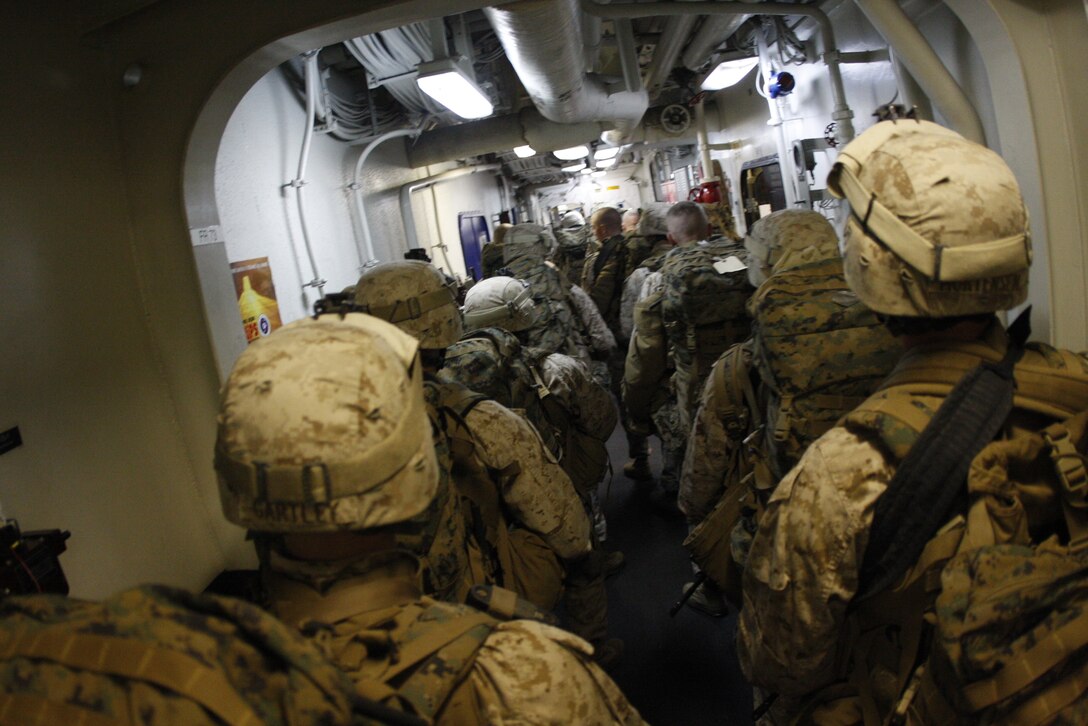 Marines with Company C, 1st Battalion, 7th Marine Regiment, navigate through narrow corridors aboard the USS Bonhomme Richard June 3. The unit is on ship for the first time in recent history, and is slated to deploy with the 31st Marine Expeditionary Unit next month.
