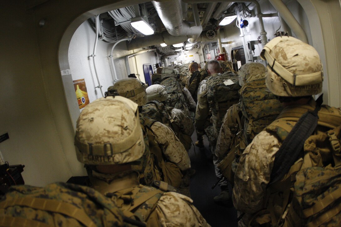 Marines with Company C, 1st Battalion, 7th Marine Regiment, crowd the hallways of the USS Bonhomme Richard after staging practice, June 3 during exercise Dawn Blitz. The exercise was meant as a display of the nation’s amphibious assault capabilities and to help prepare the Marines for their deployment with the 31st Marine Expeditionary Unit next month.