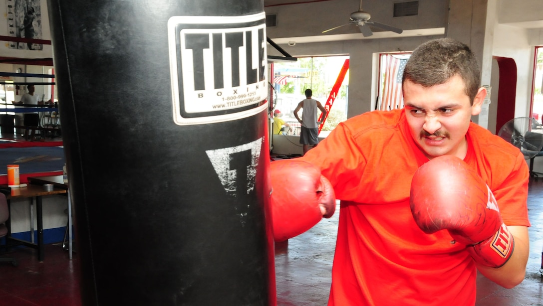 During the heavy bag portion of his workouts, Harland Wilson Aguirre-Munoz works on combinations of punches and his power to help tone and strengthen his shoulders and arms. Aguirre-Munoz, 19, has been granted the opportunity to become a U.S. Marine. (U.S. Marine Corps photo by Cpl. Fredrick J. Coleman)