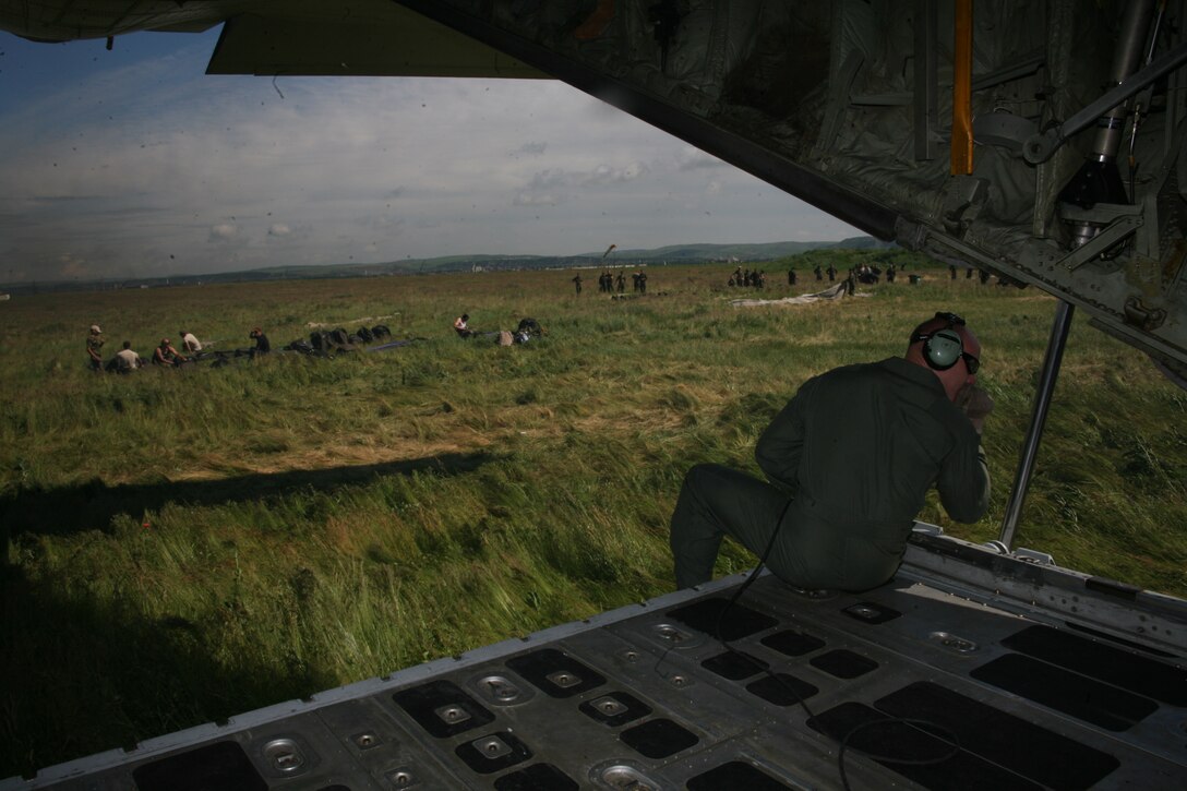 Gunnery Sgt. Gunnery Sgt. Robert Hopkins, a KC-130T loadmaster with Marine Aerial Refueler Transport Squadron 234, assists the Hercules flightcrew in positioning their aircraft on the flight line at Campia Turzii, Romania, June 2. Hopkins, a native of Providence, R.I., is one of 24 Marines from VMGR-234 and VMGR-452, currently deployed to Eastern Europe as the air combat element of the Black Sea Rotational Force Security Cooperation Marine Air-Ground Task Force.