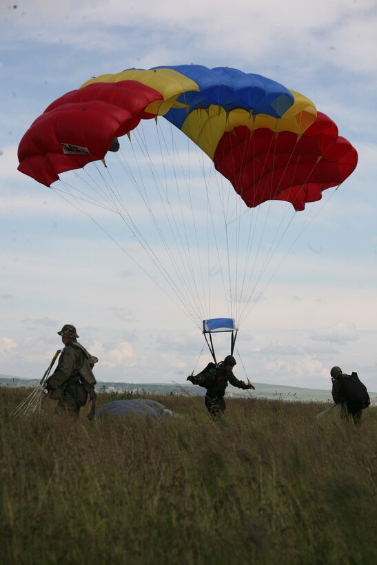 A Romanian paratrooper makes a soft landing on the grassy fields of Campia Turzii, June 2. A pair of KC-130T Hercules aircraft from Marine Aerial Refueler Transport Squadron 234 and VMGR-452, provided support for about 75 Romanian airborne troops, June 2-3.