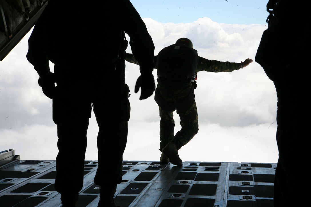 A Romanian paratrooper makes his exit from the back of a U.S. Marine Corps KC-130T Hercules aircraft, nearly 10,000 feet above Campia Turzii, June 2. A pair of KC-130T Hercules aircraft from Marine Aerial Refueler Transport Squadron 234 and VMGR-452 supported Romanian airborne troops in training, June 2-3.