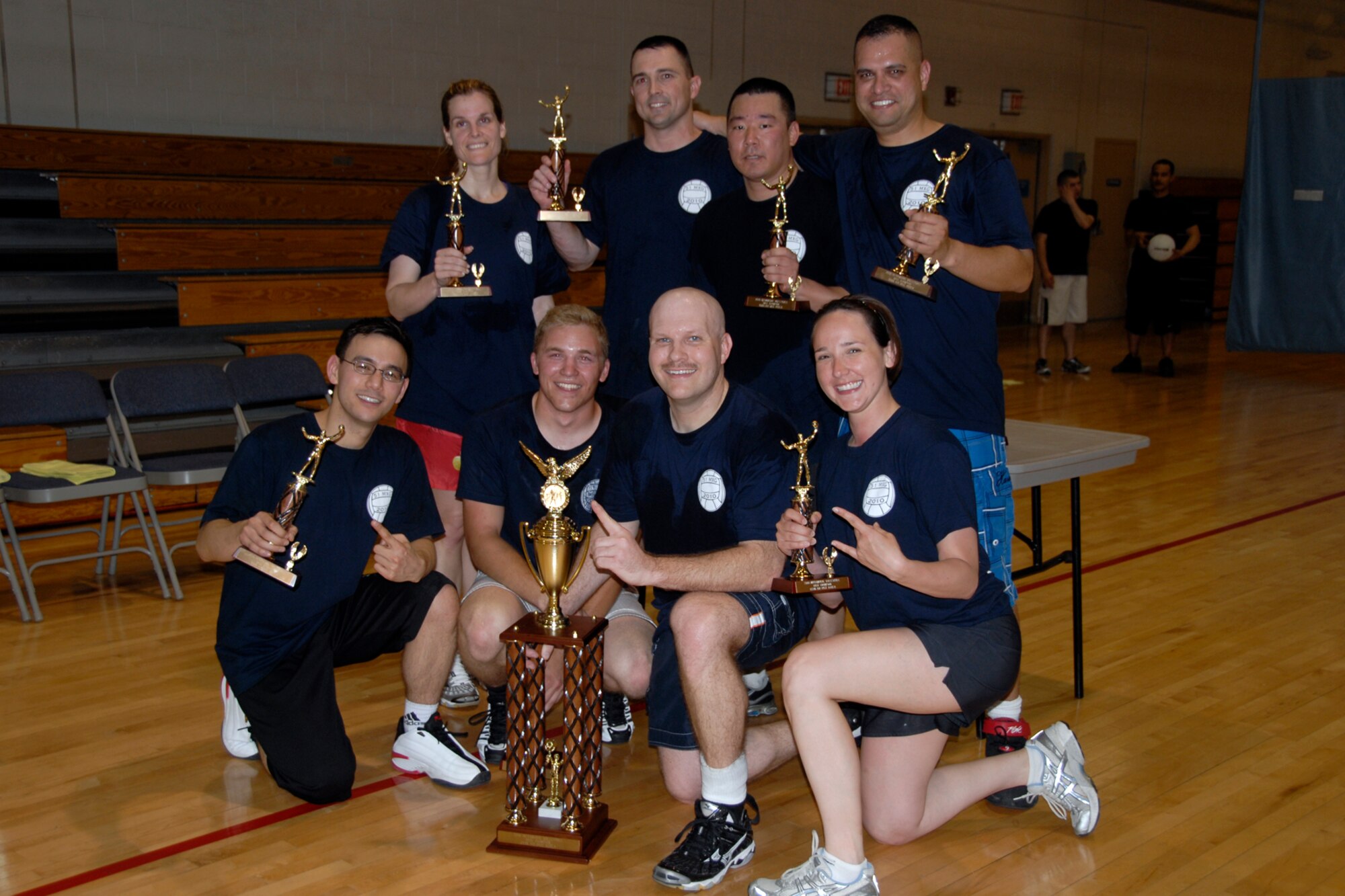 The 51st Maintenance Squadron and Maintenance Operations Squadron team gathers for a group photo after defeating the 51st Comptroller Squadron and wing staff agency team in the base intramural volleyball championship game May 27. The 51st MXS/MOS team prevailed 27-25, 21-25, 15-10, to capture this year’s title. (U.S. Air Force photo/Staff Sgt. Eric Burks)