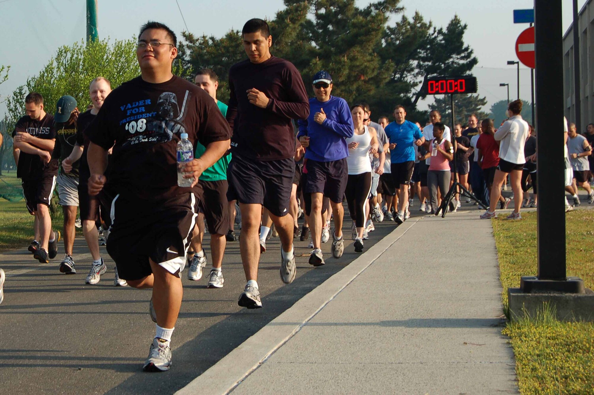 KUNSAN AIR BASE, REPUBLIC OF KOREA--8th Fighter Wing runners take off at the start of a 5K run May 21.  More than 150 Wolf Pack members participated in the run, the inaugural event of the 8th Fighter Wing Junior Enlisted Appreciation Day.  The Kunsan Top Three Association sponsored the day of music, sports, food and fun as a way to thank junior enlisted members for the hard work they do every day to accomplish the wing mission.  (U.S. Air Force Photo/Master Sgt. Anna Hayman)