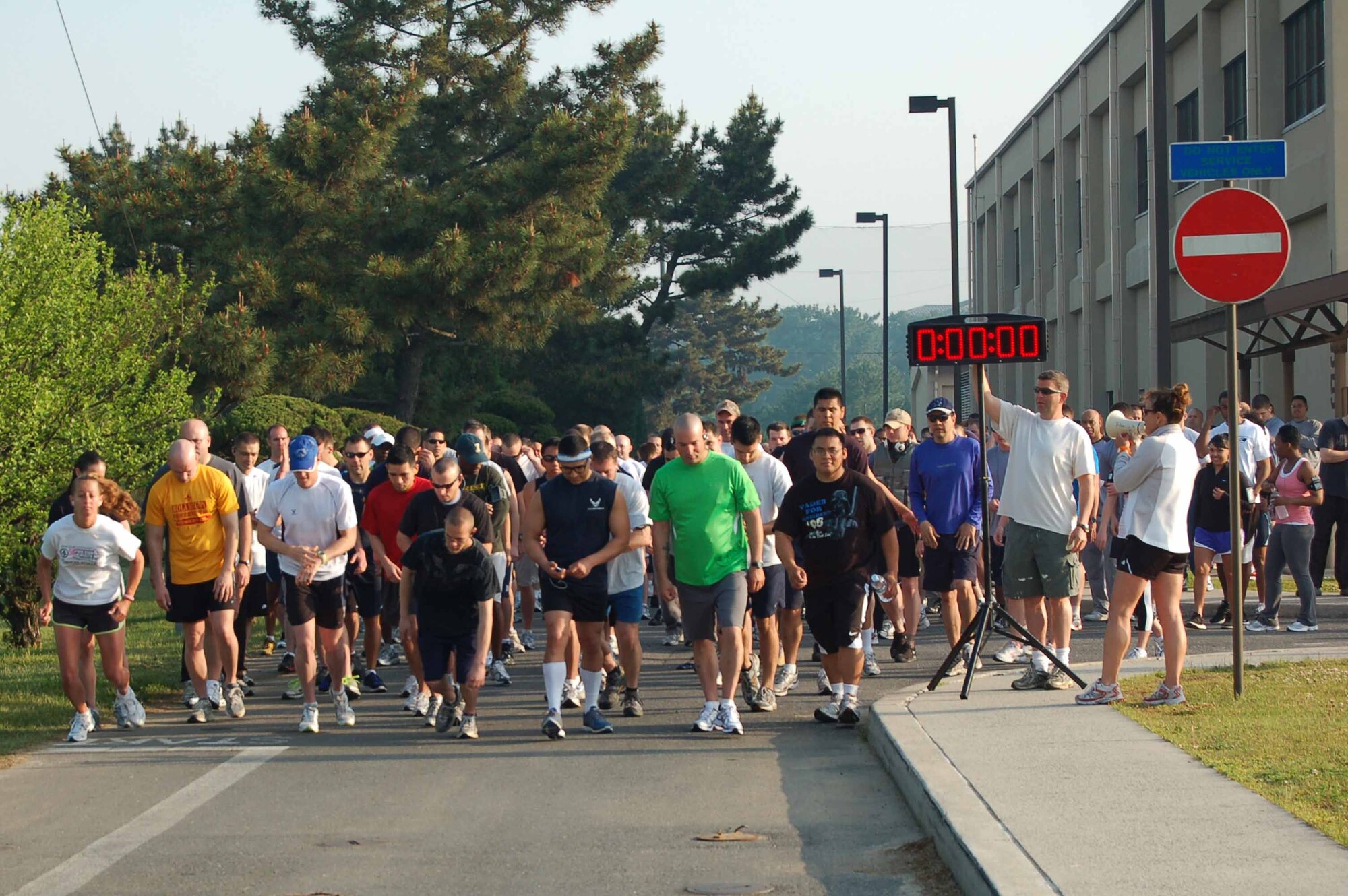 KUNSAN AIR BASE, REPUBLIC OF KOREA--Runners from the 8th Fighter Wing gather the at starting line of a 5K run May 21.  More than 150 Wolf Pack members participated in the run, the inaugural event of the 8th Fighter Wing Junior Enlisted Appreciation Day.  The Kunsan Top Three Association sponsored the day of music, sports, food and fun as a way to thank junior enlisted members for the hard work they do every day to accomplish the wing mission.  (U.S. Air Force Photo/Master Sgt. Anna Hayman)