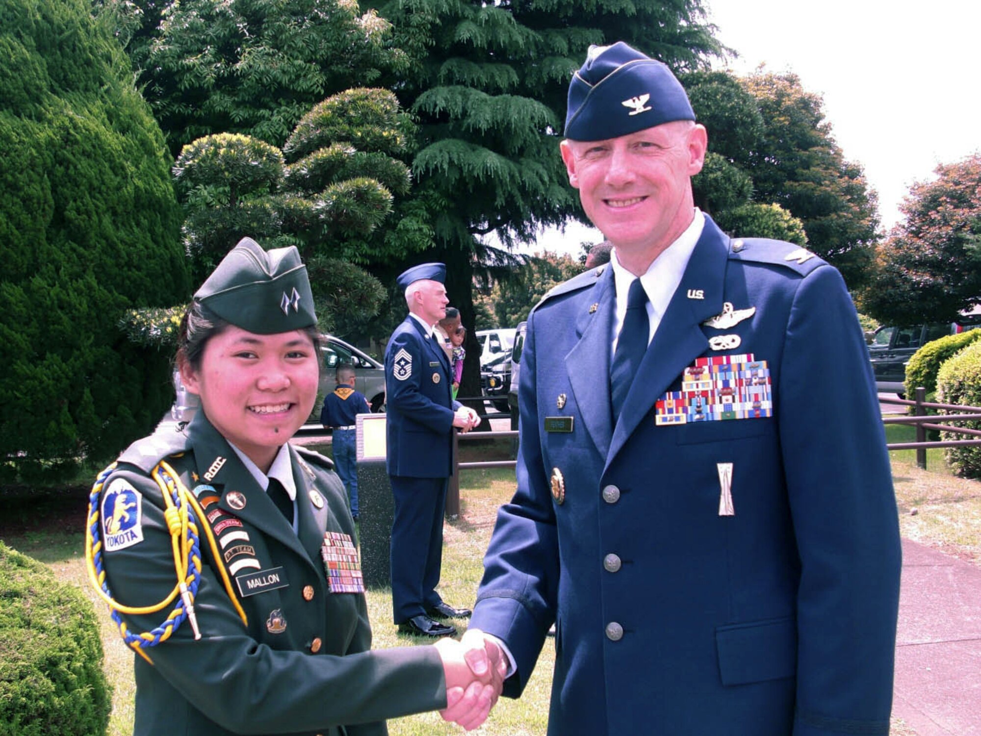YOKOTA AIR BASE, Japan -- Col. Otto Feather, 374th Airlift Wing Commander, poses with Angelica Mallon, Junior ROTC Corps Commander at the Nina Circle Memorial Day service on Monday, May 31. Memorial Day is observed on the last Monday of May and was designated to pay tribute to U.S. men and women who died while serving their country. (Courtesy photo)