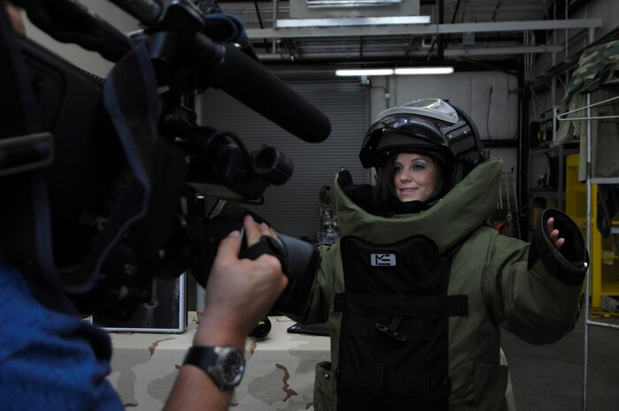 Brooke Katz, from Charleston's news Channel 2 puts on the Explosive Ordnance Disposal Bomb Suit-9 to report at Joint Base Charleston, S.C., May 7, 2010. The EOD squadron invited various media outlets to come learn about their line of work and get a feel for what they do. The bomb suit weighs approximately 70 pounds and is used to protect an EOD technician in the event of an explosion. (U.S. Air Force Photo/Airman 1st Class Lauren Main)