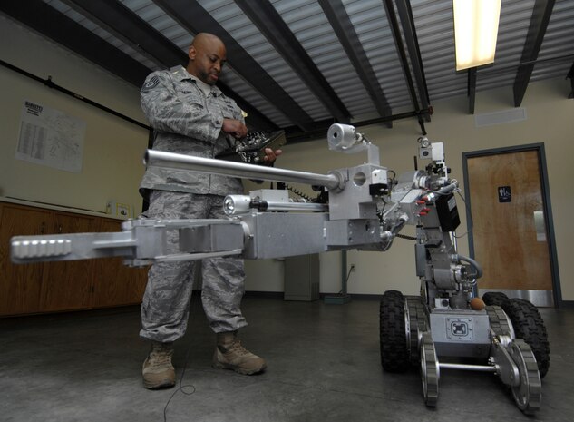 U.S. Air Force Tech. Sgt. Marion Makins operates a robot at Joint Base Charleston, S.C., May 7, 2010. The robot is one of three that was on display for the Explosive Ordnance Disposal Media Day held at the squadron to help teach people what it is that EOD does. The robot is used to safely approach explosives and is equipped with lights, an extra set of treads to balance the robot when the arm is extended and a hand to grasp and move objects that can apply up to 50 pounds of pressure. Sergeant Makins is an EOD technician with the 628 Civil Engineer Squadron. (U.S. Air Force Photo/Airman1st Class Lauren Main)