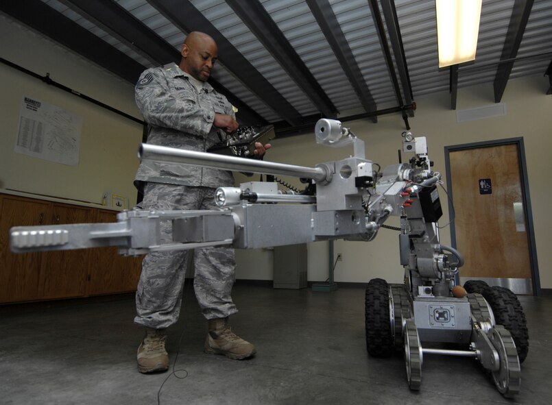 U.S. Air Force Tech. Sgt. Marion Makins operates a robot at Joint Base Charleston, S.C., May 7, 2010. The robot is one of three that was on display for the Explosive Ordnance Disposal Media Day held at the squadron to help teach people what it is that EOD does. The robot is used to safely approach explosives and is equipped with lights, an extra set of treads to balance the robot when the arm is extended and a hand to grasp and move objects that can apply up to 50 pounds of pressure. Sergeant Makins is an EOD technician with the 628 Civil Engineer Squadron. (U.S. Air Force Photo/Airman1st Class Lauren Main)