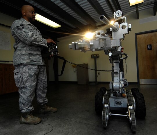 U.S. Air Force Tech. Sgt. Marion Makins operates a robot at Joint Base Charleston, S.C., May 7, 2010. The robot is one of three that was on display for the Explosive Ordnance Disposal Media Day held at the squadron to help teach people what it is that EOD does. The robot is used to safely approach explosives and is equipped with lights, an extra set of treads to balance the robot when the arm is extended and a hand to grasp and move objects that can apply up to 50 pounds of pressure. Sergeant Makins is an EOD technician with the 628 Civil Engineer Squadron. (U.S. Air Force Photo/Airman1st Class Lauren Main)