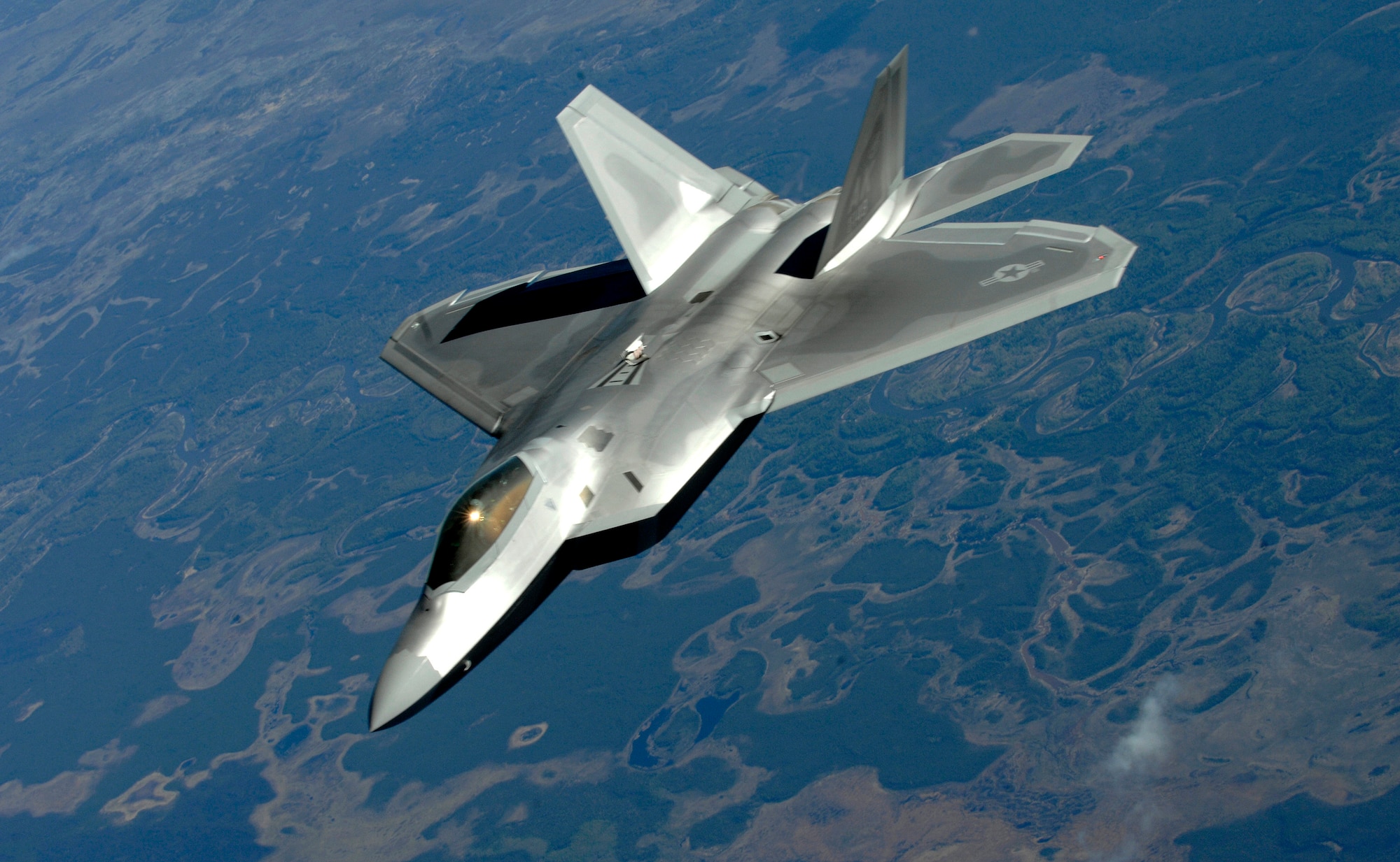 An F-22 Raptor from Elmendorf Air Force Base pulls alongside a KC-135 Stratotanker (simulating a Boeing 747) after federal air marshals subdue a simulated terrorist onboard the plane during Arctic Fencing Inter-Agency Arrow 2010 field training exercise May 26. During this exercise Department of Defense, Department of Justice and Department of Homeland Security personnel worked together to resolve a simulated terrorist hijacking of a commercial aircraft from the initial in flight tactical response until the aircraft was safely escorted to the airport and secured by agents on the ground. (U.S. Air force photo/Staff Sgt. Brian Ferguson)