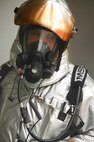 MINOT AIR FORCE BASE, N.D. -- Senior Airman Scott Morisette, 5th Civil Engineering Squadron fire fighter, busts out the back door of a smoking house on base during a training exercise here May 21. Fire fighters take part in routine exercises to maintain excellence in their skills. (U.S. Air Force photo by Airman 1st Class Aaron-Forrest Wainwright)
