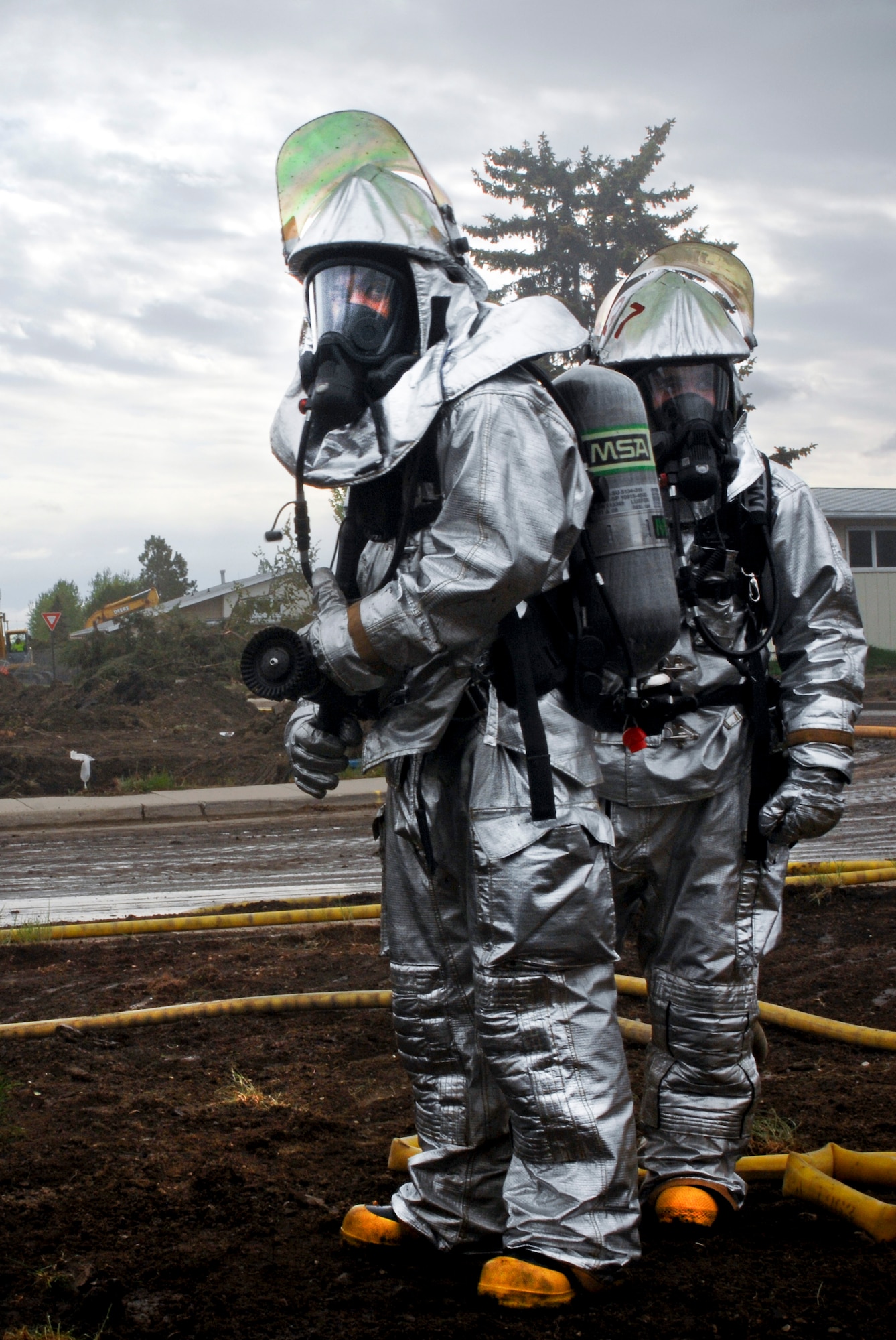 MINOT AIR FORCE BASE, N.D. -- Airman Jose Lopez and Airman 1st Class Robert Martin, 5th Civil Engineer Squadron fire fighters, stand ready during a training exercise here May 21. The fire fighters participated in routine exercises to maintain excellence in their skills. (U.S. Air Force photo by Airman 1st Class Aaron-Forrest Wainwright)