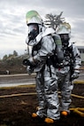 MINOT AIR FORCE BASE, N.D. -- Airman Jose Lopez and Airman 1st Class Robert Martin, 5th Civil Engineer Squadron fire fighters, stand ready during a training exercise here May 21. The fire fighters participated in routine exercises to maintain excellence in their skills. (U.S. Air Force photo by Airman 1st Class Aaron-Forrest Wainwright)