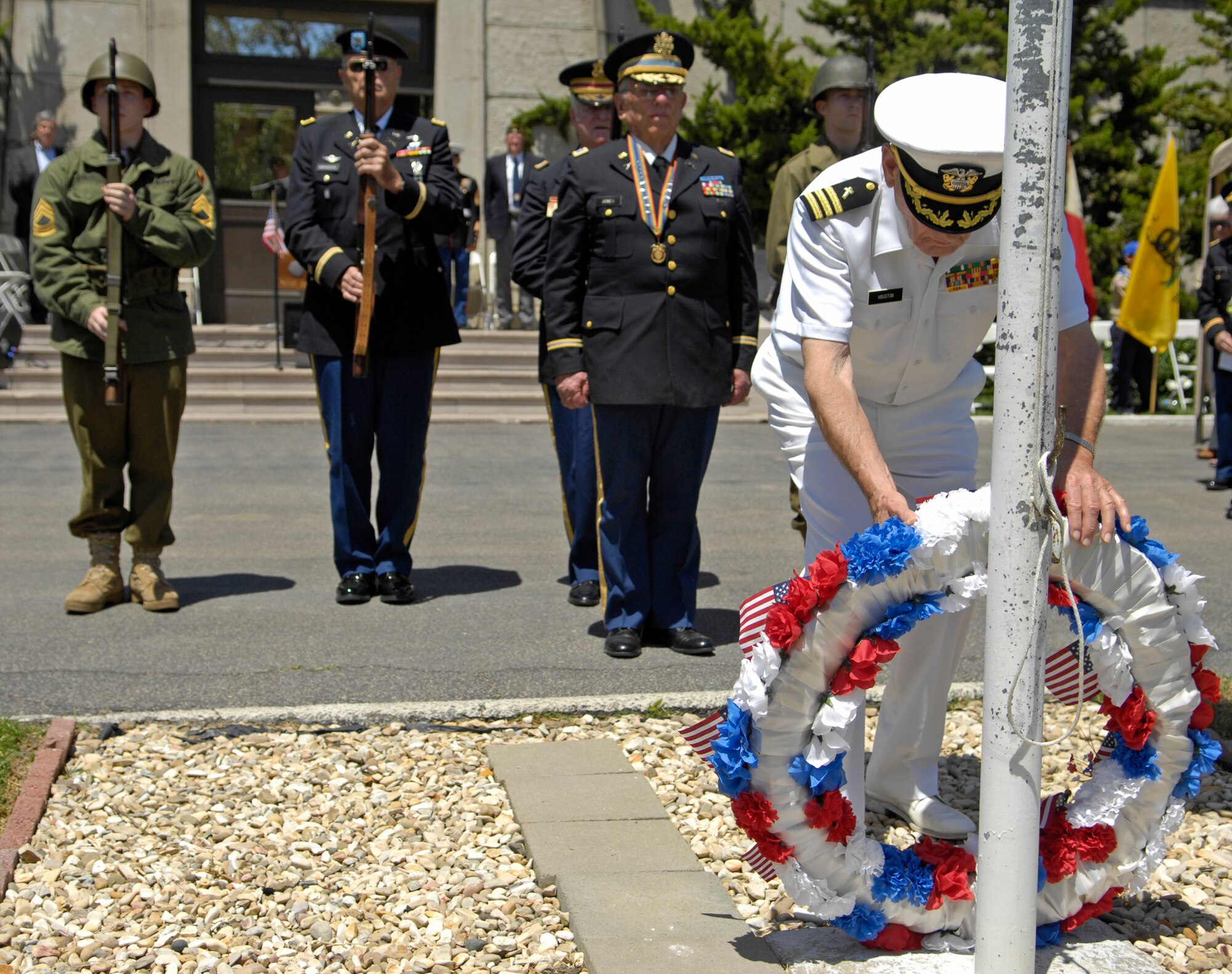 SAN LUIS OBISPO, Calif. -- Chaplain William Houston, retired Navy chaplain, leads the honor guard in the presentation and placing of a floral wreath, during a Memorial Day service here Monday, May 31, 2010.  (U.S. Air Force photo/Senior Airman Andrew Lee) 