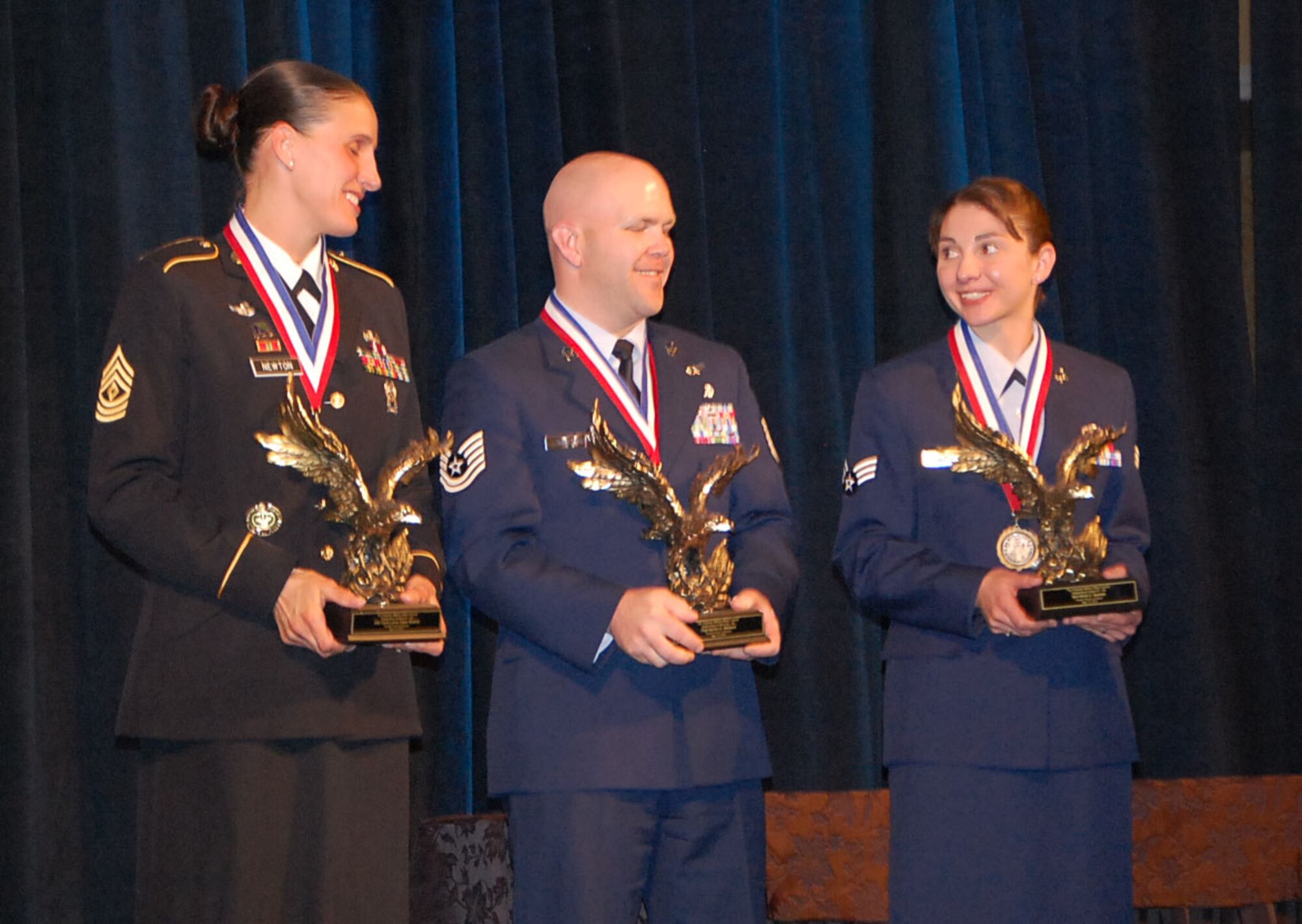 Senior Airman Olivia Gorman, 21st Contracting Squadron, (right) is named Outstanding Enlisted Personnel by the Colorado Springs Chamber of Commerce Military Affairs Division, which honored a dozen enlisted personnel at a luncheon May 15, as part of Armed Forces Week. Men and women from the Air Force, Army and Reserves were nominated by their installations. (Courtesy photo)