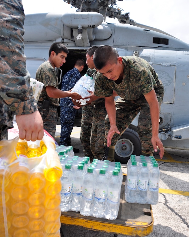 Guatemalan military members along with U.S. servicemembers load a SH-60F Seahawk with humanitarian aid June 2 at the Guatemala City Airport. At the request of the Guatemalan government, U.S. military aircraft conducted their first humanitarian missions to support humanitarian assistance efforts in Guatemala following Tropical Storm Agatha. (U.S. Air Force photo by Staff Sgt. Bryan Franks)
