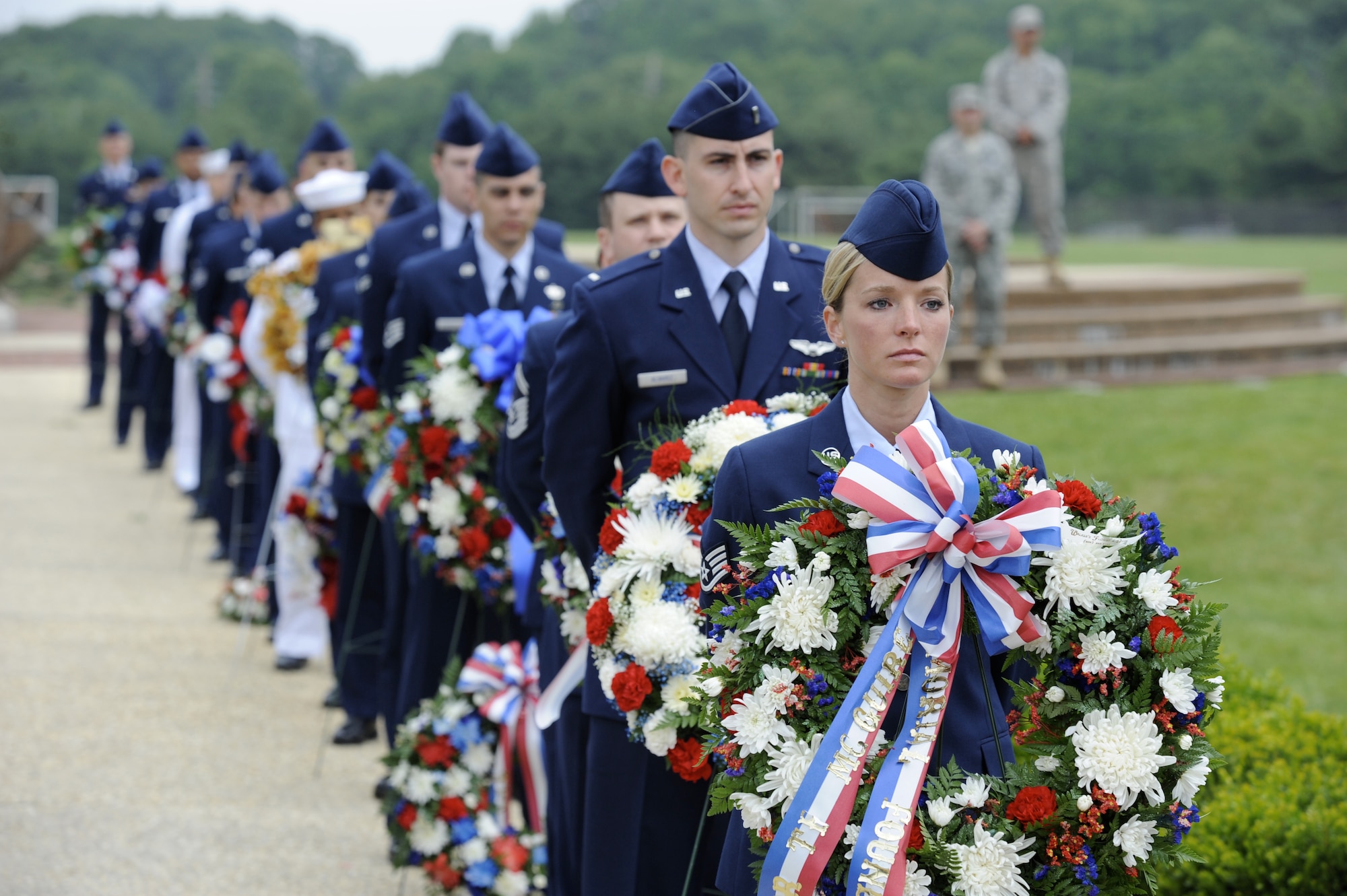 Servicemembers from Joint Base McGuire-Dix-Lakehurst form a parade route for the wreaths during the Parade of Wreaths ceremony May 27 here. The parade route began at the base flag pole and ended at the base of the Thomas B. McGuire P-38, in Pudgy Circle. (U.S. Air Force photo/Wayne Russell)
