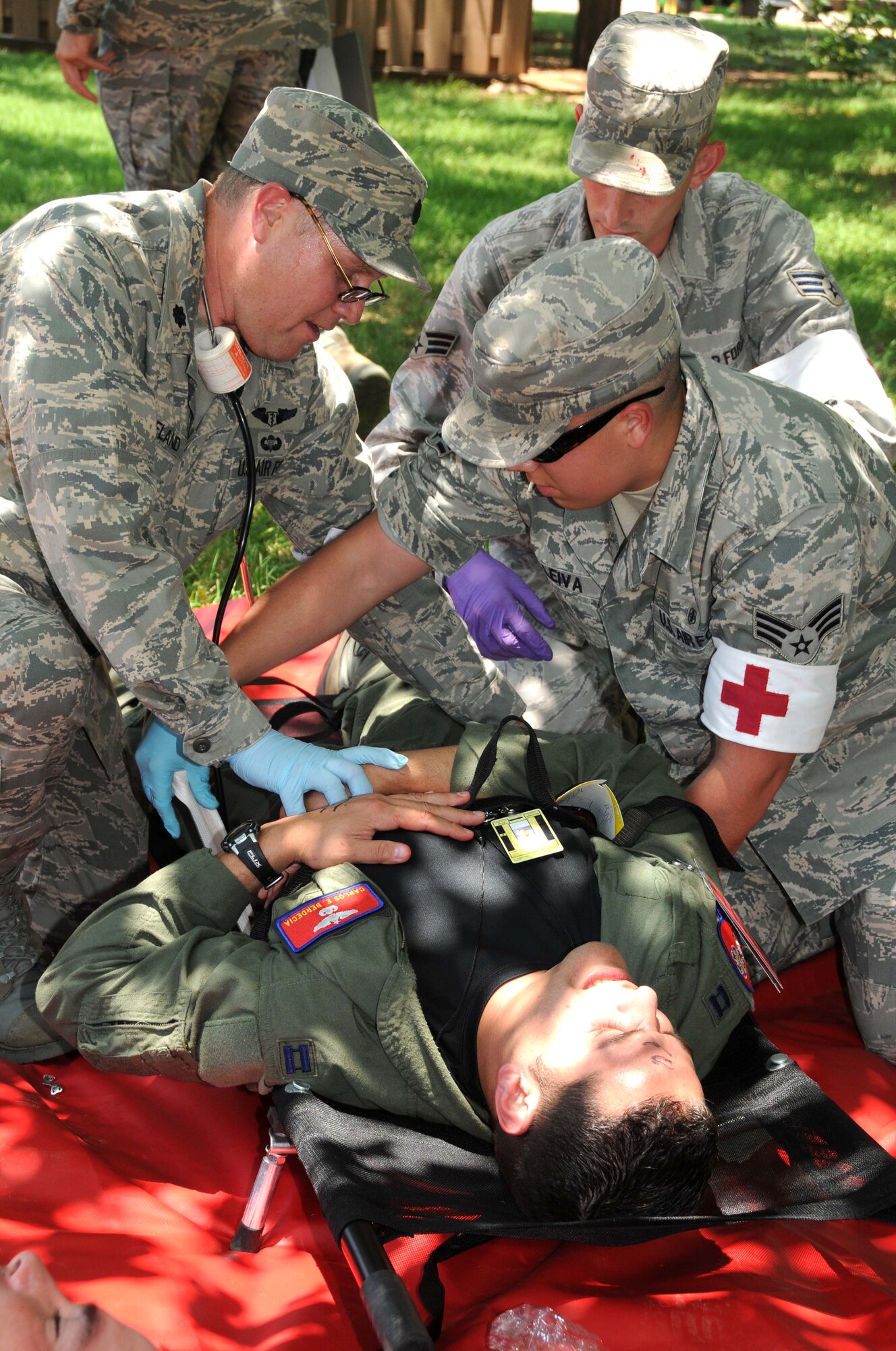 ALTUS AIR FORCE BASE, Okla. -- Members from the 97th Medical Group provide medical assistance to a role player during the force protection exercise June 1.  Over 65 role players from around the base volunteered to help make the exercise as realistic as possible. (U.S. Air Force photo / Senior Airman Cherice Bryant / Released / 97th Air Mobility Wing Public Affairs)