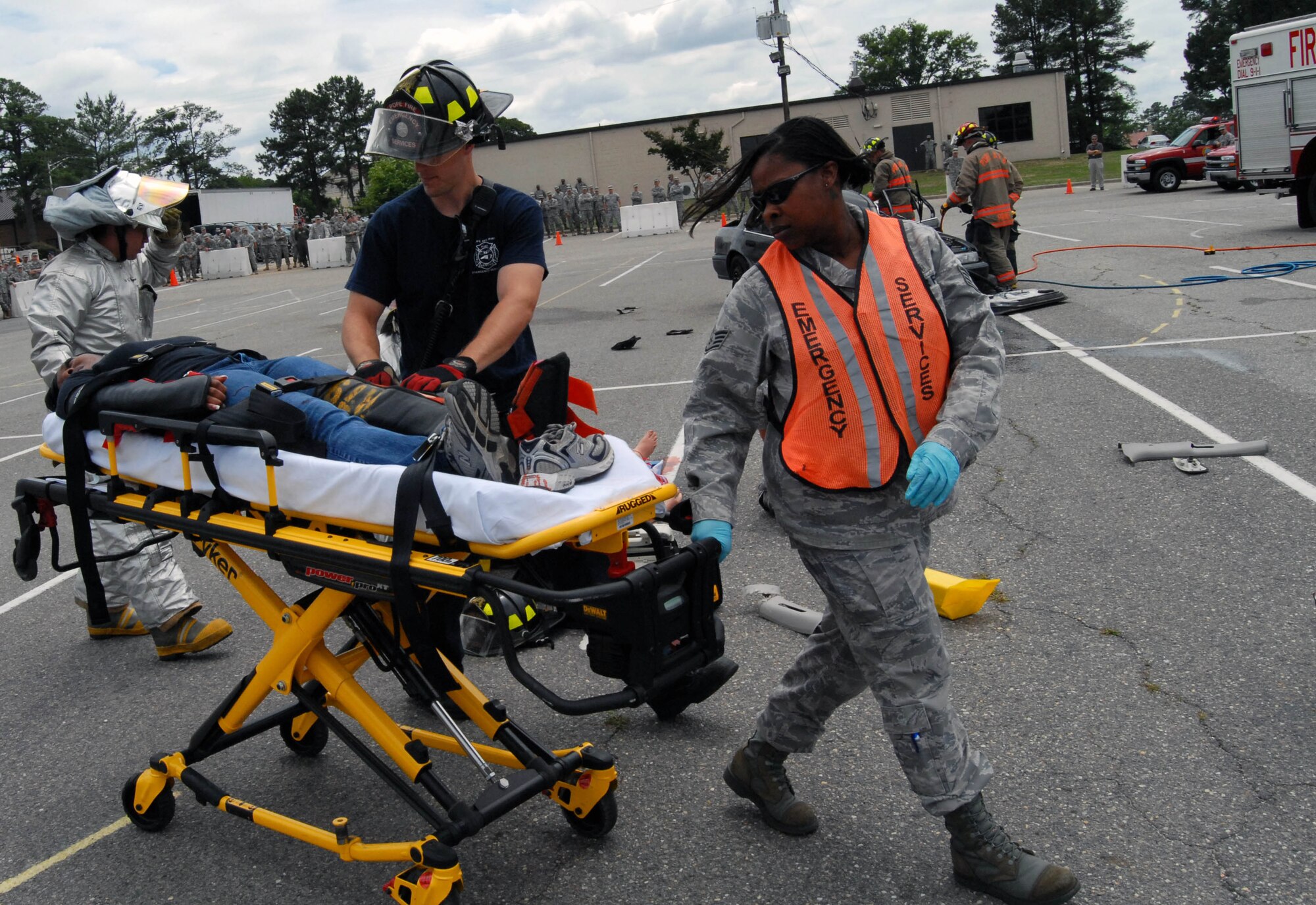 Pope emergency responders carry Senior Airman Brittany Roberts, 43rd Operations Support Squadron, to an ambulance during a demonstration about the repercussions of driving under the influence of alcohol at the Pope Theater, May 27. The Air Force recognizes the time period between Memorial Day and Labor Day as one which presents an increase in safety concerns and challenges to all Airmen.  (U.S. Air Force Photo/1st Lt. Cammie Quinn)