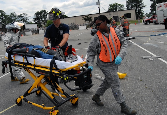 Pope emergency responders carry Senior Airman Brittany Roberts, 43rd Operations Support Squadron, to an ambulance during a demonstration about the repercussions of driving under the influence of alcohol at the Pope Theater, May 27. The Air Force recognizes the time period between Memorial Day and Labor Day as one which presents an increase in safety concerns and challenges to all Airmen.  (U.S. Air Force Photo/1st Lt. Cammie Quinn)