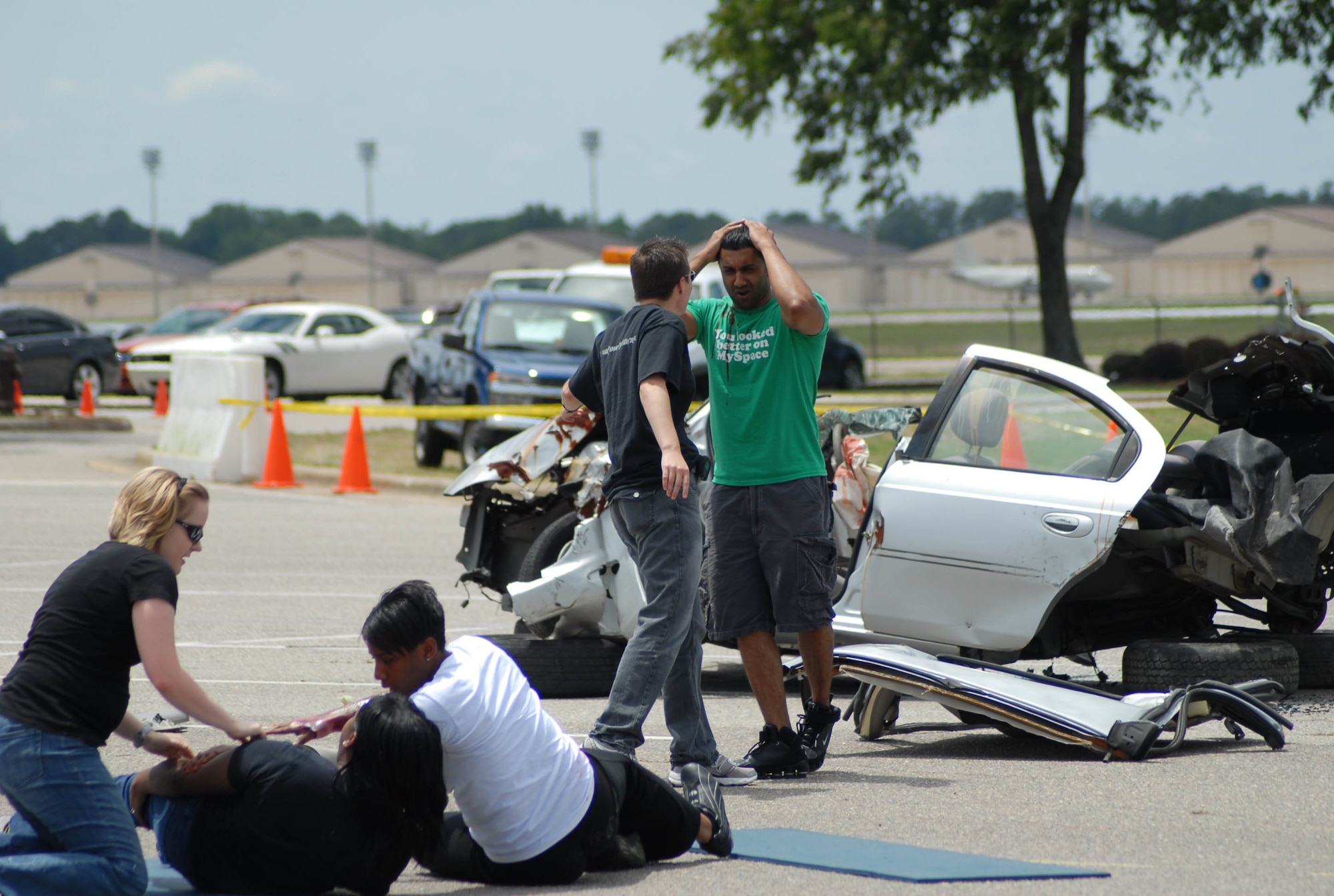 Staff Sgt. Mark Nasirali, 43rd Logistics Readiness Squadron (far right), observes the simulated damage from vehicle accident he caused while driving under the influence of alcohol at the Pope Theater, May 28 as Senior Airmen Tamesha Green, 43rd Medical Operations, and Brittany Roberts, 43rd Operations Support Squadron lay in the street, injured. As part of a dramatic skit, Sergeant Nasirali simulated hitting a car carrying three Airmen to demonstrate the possible repercussions of DUIs. (U.S. Air Force Photo/Senior Airman Mindy Bloem)