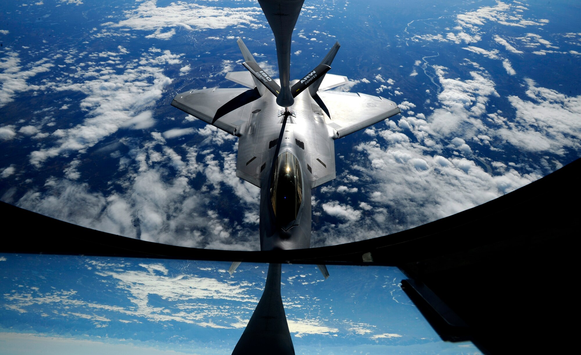 An F-22 Raptor from Elmendorf Air Force Base, Alaska, receives fuel from a KC-135 Stratotanker from the Kansas Air National Guard's 190th Air Refueling Wing May 26, 2010. The refueling took place over Alaska.  (U.S. Air Force photo/Staff Sgt. Brian Ferguson)
