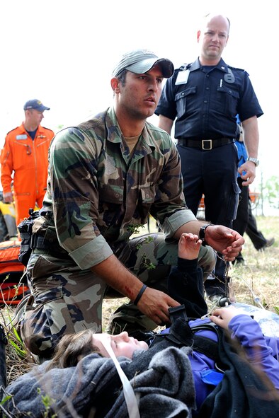 17 WING WINNIPEG, Man., - U.S. Air Force Reserve pararescuman, Senior Airman Brandon Forshaw from the 920th Rescue Wing, Patrick Air Force Base, Fla., attends to a casualty at a scene during the 2010 Grand Prairie search and rescue exercise. From 14-18 May 2010, members of 435 Search and Rescue Squadron, out of Winnipeg Manitoba, 440 Squadron from Yellowknife, along with members of Civil Air Search and Rescue Association (CASARA), the 920th RQW and various other local emergency response groups and organizations in Grande Prairie Alberta, participated in the SAREX.
The exercise consisted of searches from the air, parachute  jumps by the PJs and SARTechs, casualty air extraction by STARS and ground evacuation by local EMS technicians. The exercise also consisted of precision aircraft landing by the HC-130 Hercules aircraft (both American and Canadian) as well as accuracy cargo drops and parachute accuracy jumps. (photo by/Cpl. Colin Aitken)

