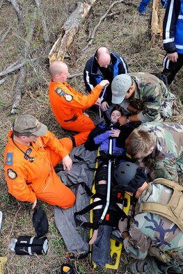 17 WING WINNIPEG, MANITOBA, Canada - Canadian search and rescue technicians work hand-in-hand with 920th Rescue Wing reserve pararescuemen or PJs during the 2010 Grand Prairie search and rescue exercise May 14-18. The Reservists from the 920th RQW, Patrick Air Force Base, Fla., put their training to the test extracting "victims" from mountainous terrain which which is not available for training in the Florida flatlands. The 920th RQW is the most called upon unit in the U.S. Air Force Reserve. Its mission is combat search and rescue, civilian search and rescue and astrounaut shuttle and rocket launch support. (U.S. Air Force photo/Corporal. Colin Aitken) 

