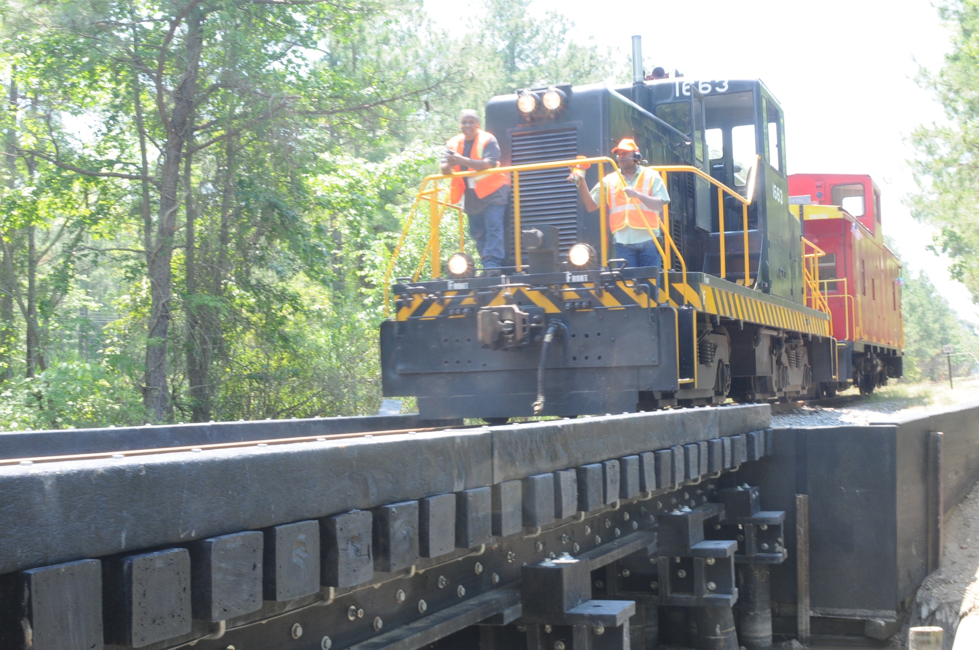 FORT EUSTIS, Va. -- A U.S. Army Transportation School locomotive and caboose makes its way across Bridge #3 May 27 at Fort Eustis as part of a demonstration for the Recycled Structural Composite Bridge Media Day. The new bridge has a load capacity of up to 130 tons. (U.S. Air Force photo/Tetaun Moffett)