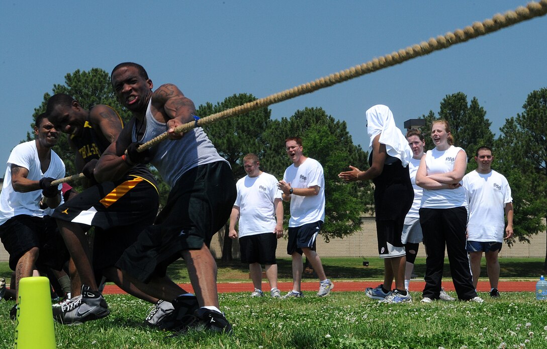 LANGLEY AIR FORCE BASE, Va. -- Staff Sgt. Carl Dixon, 735th Supply Chain Management Group ground MICAP assistant noncommissioned officer in charge, and his team participate in the tug-o-war during the Squadron Fitness Challenge May 27. Eighteen teams participated in the annual event wrapping up May fitness month, hosted by the 633d Force Support Squadron and Prism Sports to promote a healthy, active lifestyle.  (U.S. Air Force Photo/Staff Sgt. Christina M. Styer)             