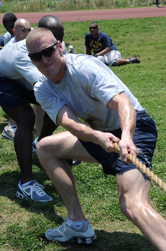 LANGLEY AIR FORCE BASE, Va. -- Staff Sgt. Brandon Phelps, 633d Security Forces Squadron unit training instructor, and his team participate in and take the tug-o-war title during the Squadron Fitness Challenge May 27. Eighteen teams participated in the annual event wrapping up May fitness month, hosted by the 633d Force Support Squadron and Prism Sports to promote a healthy, active lifestyle.  (U.S. Air Force Photo/Staff Sgt. Christina M. Styer)         