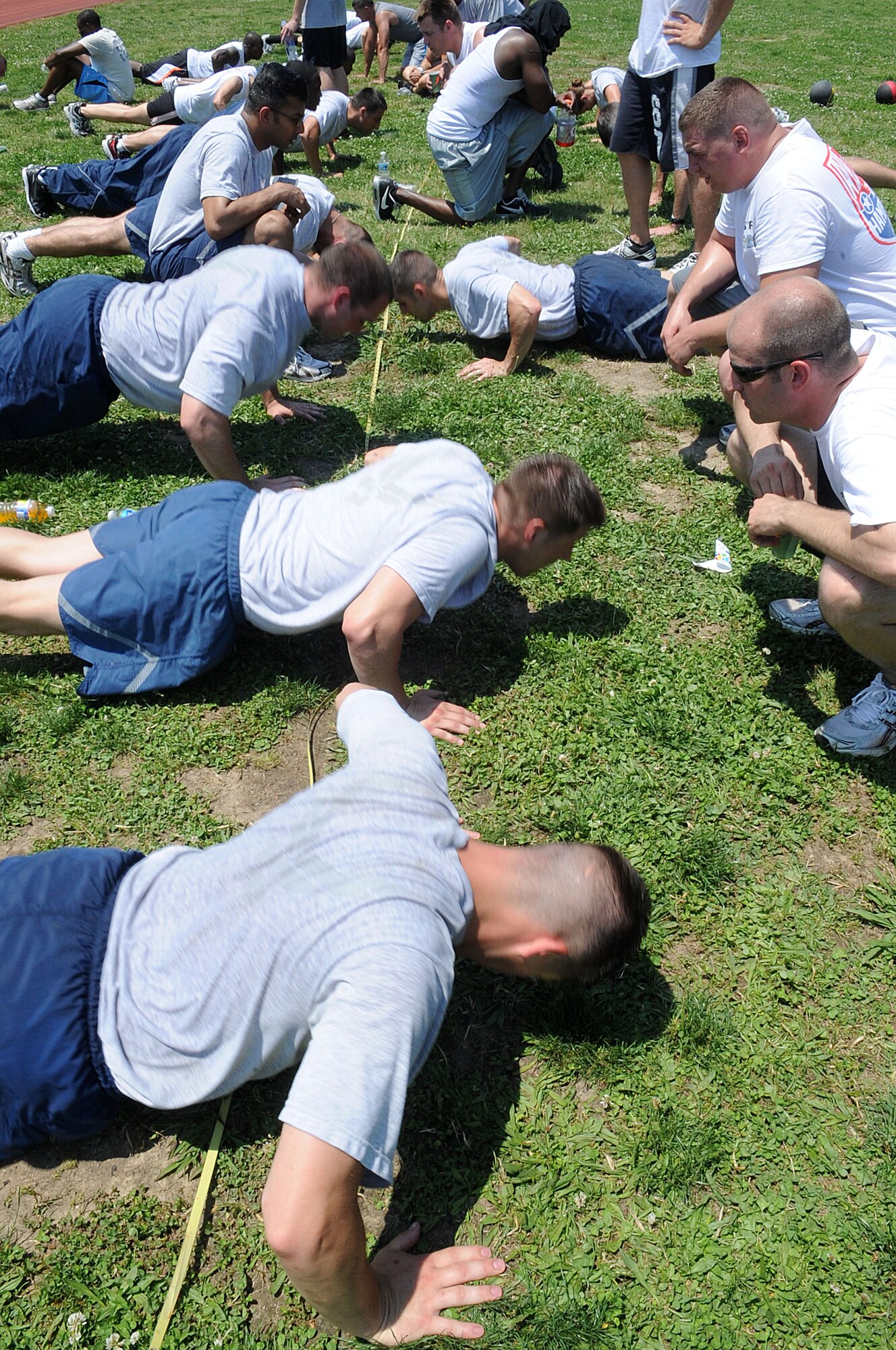 LANGLEY AIR FORCE BASE, Va. -- Teams of six from various organizations compete against each other to compile the most push-ups during the Squadron Fitness Challenge May 27. Eighteen teams participated in the annual event wrapping up May fitness month, hosted by the 633d Force Support Squadron and Prism Sports to promote a healthy, active lifestyle.  (U.S. Air Force Photo/Staff Sgt. Christina M. Styer)  
