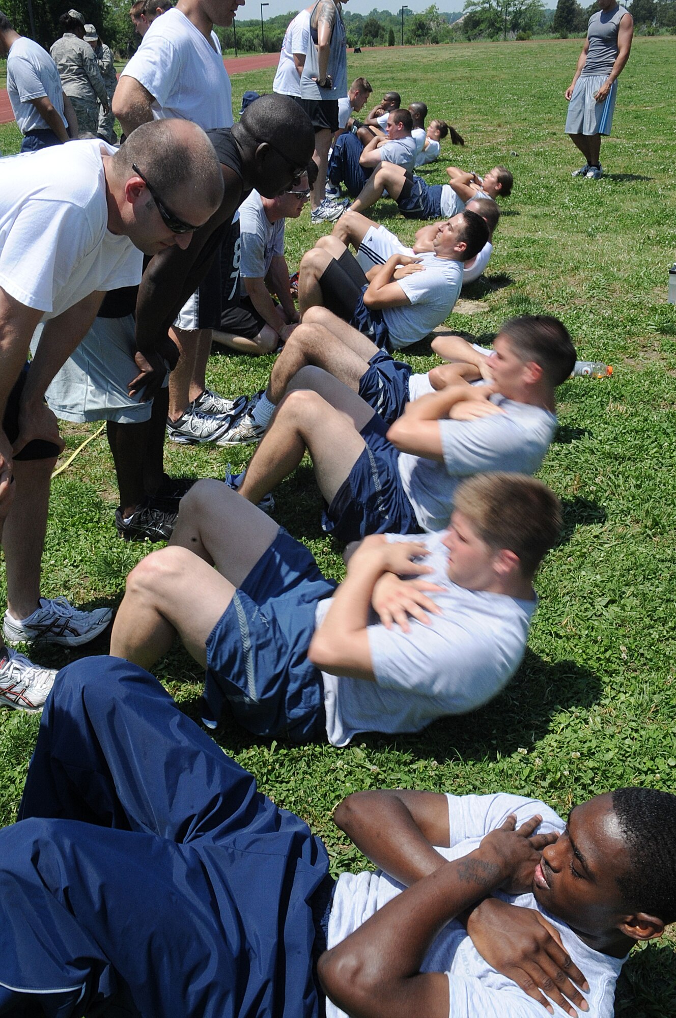 LANGLEY AIR FORCE BASE, Va. -- Members of the 36th Intelligence Squadron, compete in the sit-up competition during the Squadron Fitness Challenge May 27. Eighteen teams participated in the annual event wrapping up May fitness month, hosted by the 633d Force Support Squadron and Prism Sports to promote a healthy, active lifestyle.  (U.S. Air Force Photo/Staff Sgt. Christina M. Styer)      