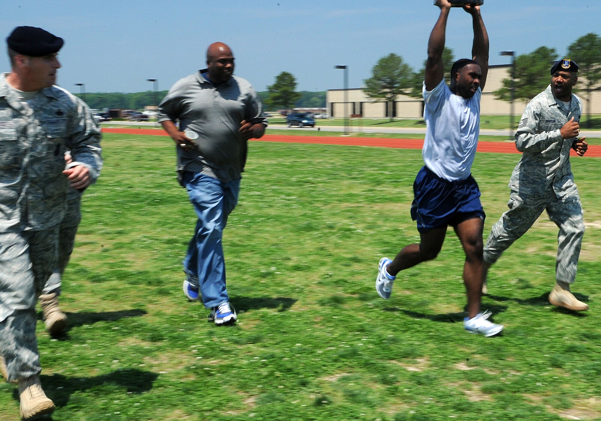 LANGLEY AIR FORCE BASE, Va. -- Security Forces leadership motivate Staff Sgt. Carl Bray, 633 SFS corrections assistant noncommissioned officer in charge, competes in Squadron Fitness Challenge May 27. Eighteen teams participated in the annual event wrapping up May fitness month, hosted by the 633d Force Support Squadron and Prism Sports to promote a healthy, active lifestyle.  (U.S. Air Force Photo/Staff Sgt. Christina M. Styer)    