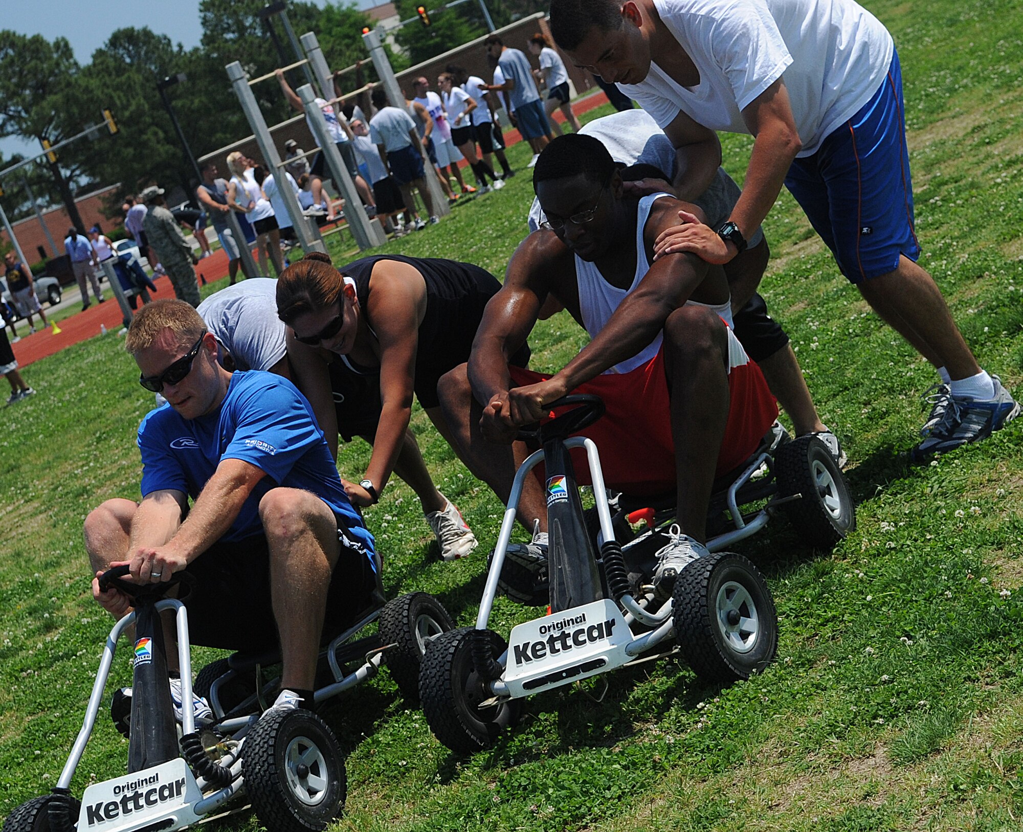 LANGLEY AIR FORCE BASE, Va. -- The 633d Force Support Squadron competes in the go-kart relay during the Squadron Fitness Challenge May 27. Eighteen teams participated in the annual event wrapping up May fitness month, hosted by the 633d Force Support Squadron and Prism Sports to promote a healthy, active lifestyle.  (U.S. Air Force Photo/Staff Sgt. Christina M. Styer)      