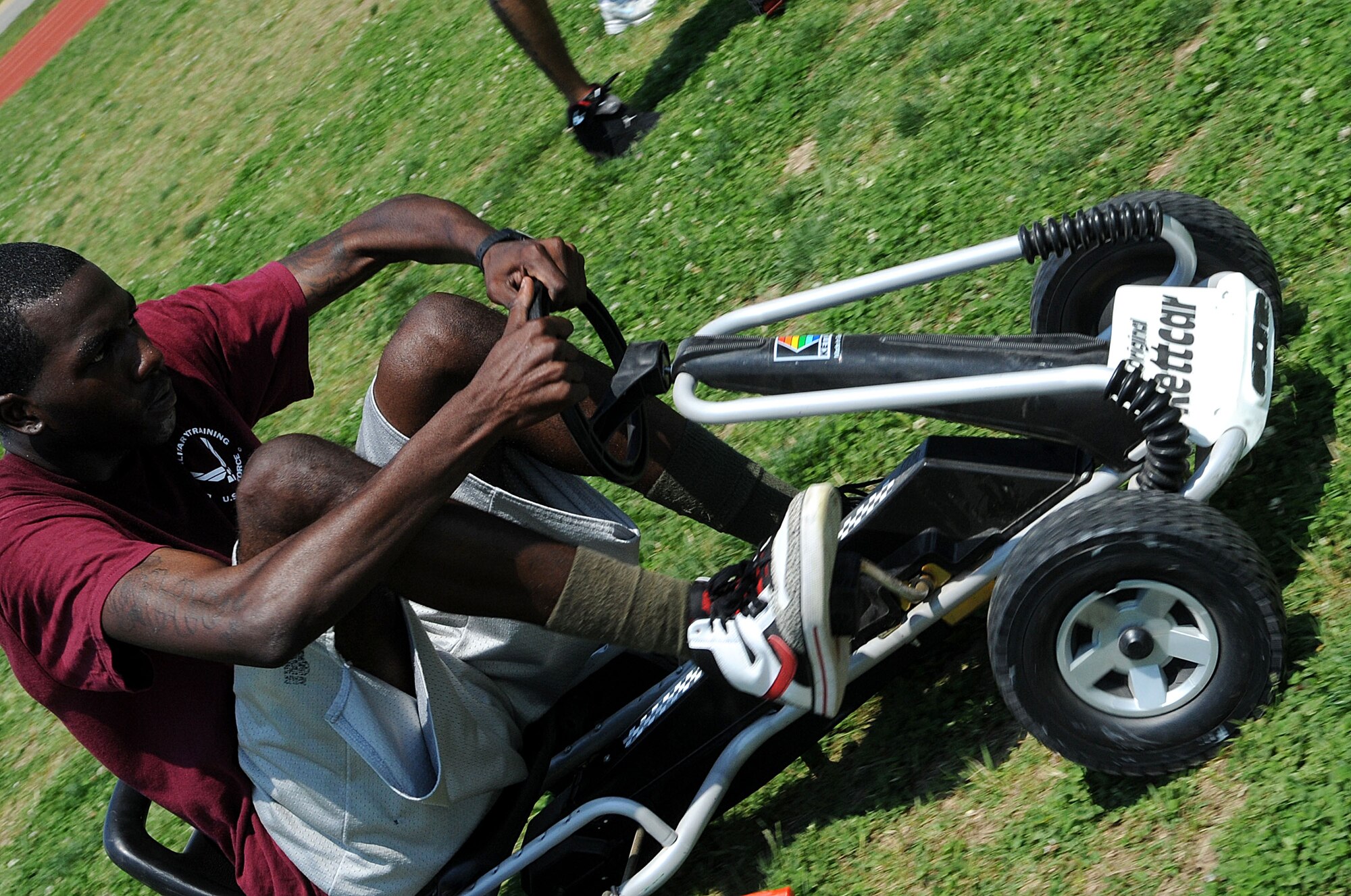LANGLEY AIR FORCE BASE, Va. -- Airman 1st Class Curtis Duckworth, 735th Supply Chain Management Group, competes in the go-kart relay during the Squadron Fitness Challenge May 27. Eighteen teams participated in the annual event wrapping up May fitness month, hosted by the 633d Force Support Squadron and Prism Sports to promote a healthy, active lifestyle.  (U.S. Air Force Photo/Staff Sgt. Christina M. Styer)      