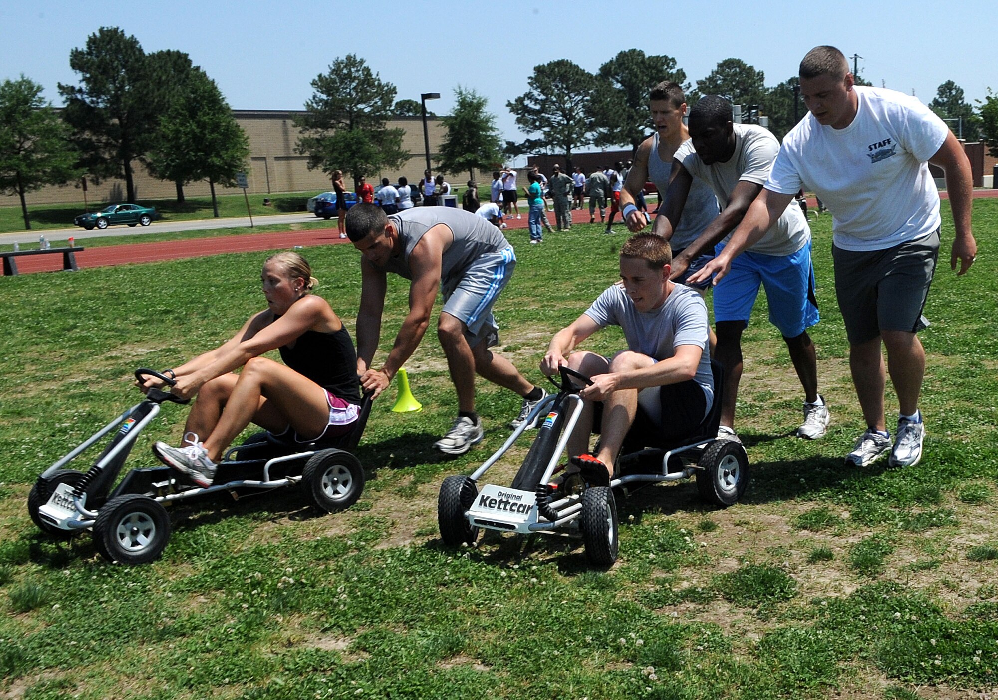 LANGLEY AIR FORCE BASE, Va. -- The 633d Contracting Squadron team participates in the Go-kart relay during the Squadron Fitness Challenge hosted by the 633d Force Support Squadron and Prism Sports May 27.  Eighteen teams participated in the annual event wrapping up May fitness month to promote a healthy, active lifestyle.  (U.S. Air Force Photo/Staff Sgt. Christina M. Styer)  
