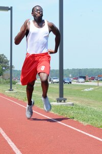 LANGLEY AIR FORCE BASE, Va. -- Airman 1st Class Italy Williams, 633d Force Support Squadron, Eagle Room Dining Facility staff, runs 100 yards of his team’s 600 yard dash during the Squadron Fitness Challenge May 27. The Squadron Fitness Challenge is an annual event wrapping up May fitness month and was hosted by the 633d Force Support Squadron and Prism sports.  (U.S. Air Force Photo/Staff Sgt. Christina M. Styer) 